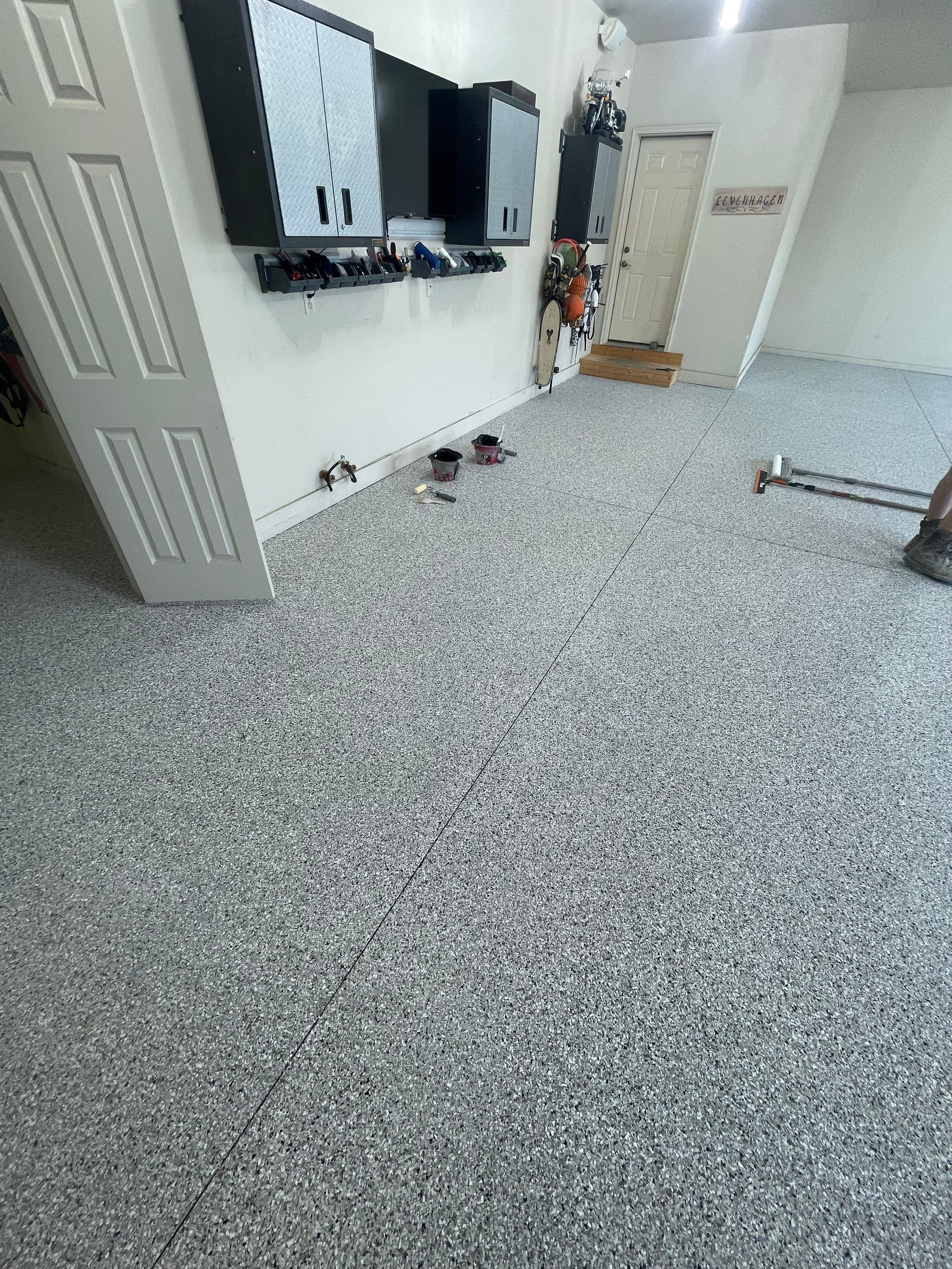 Coyote Flake Garage Floor Coating in Sioux Falls with Trench Drain by Select Painting, Coatings & Garage Cabinets