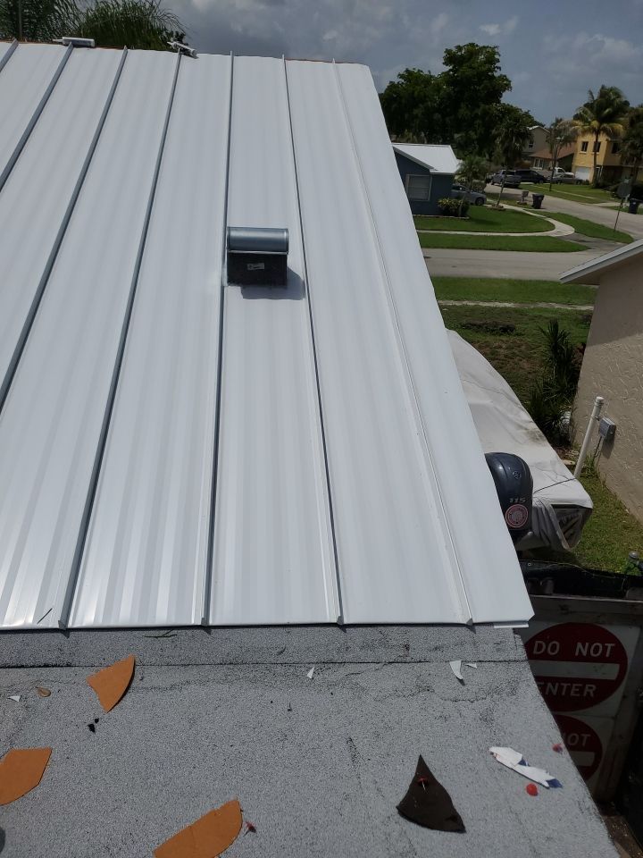 Residential Roofing Installation using 1.5" Nail Strip 24ga Solar White Kynar Coated Standing Seam Metal Panels by Morton Roofing, Inc.