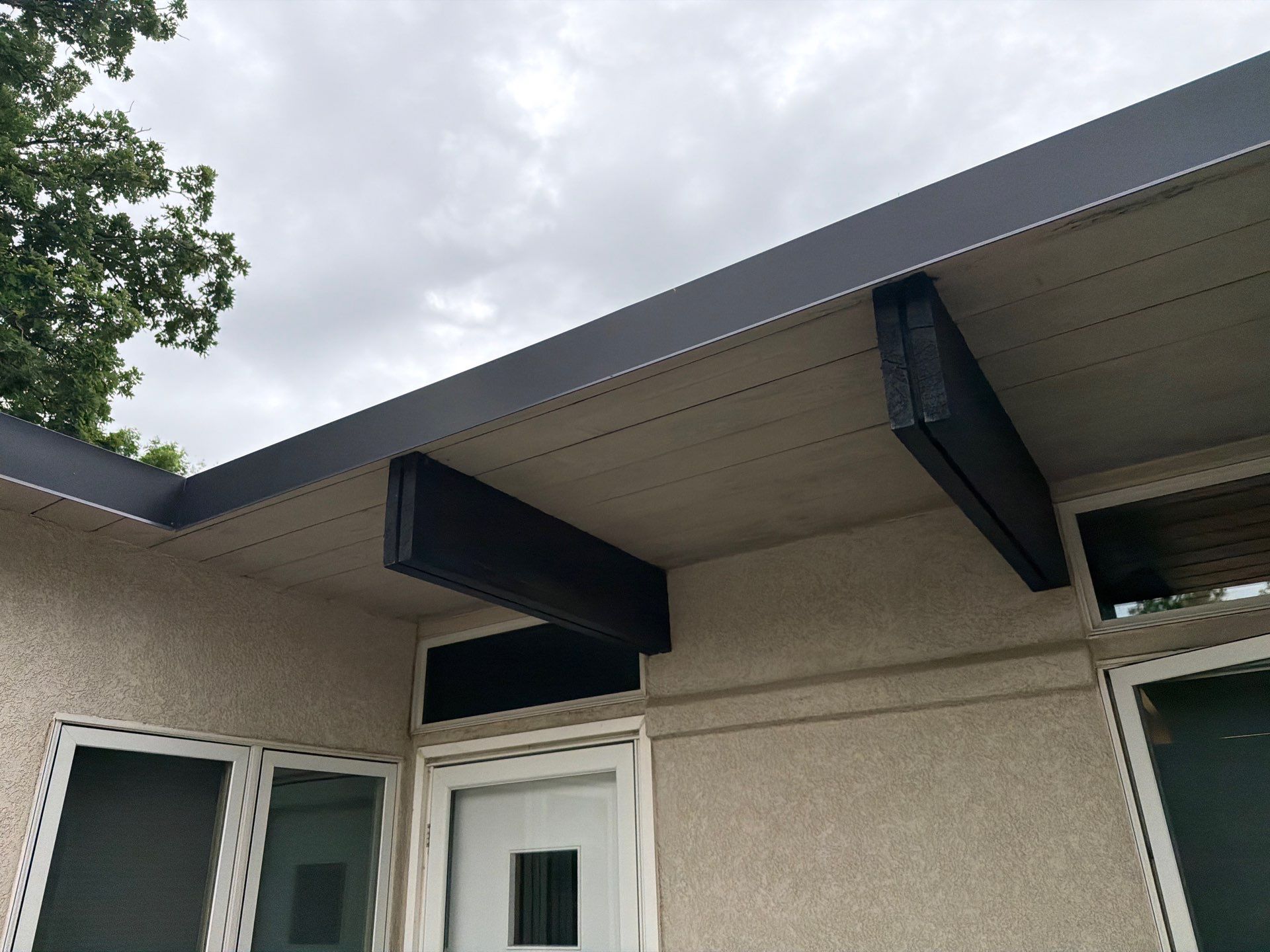 Exterior Trim Painting and Rafter Staining in Sioux Falls by Select Painting, Coatings & Garage Cabinets