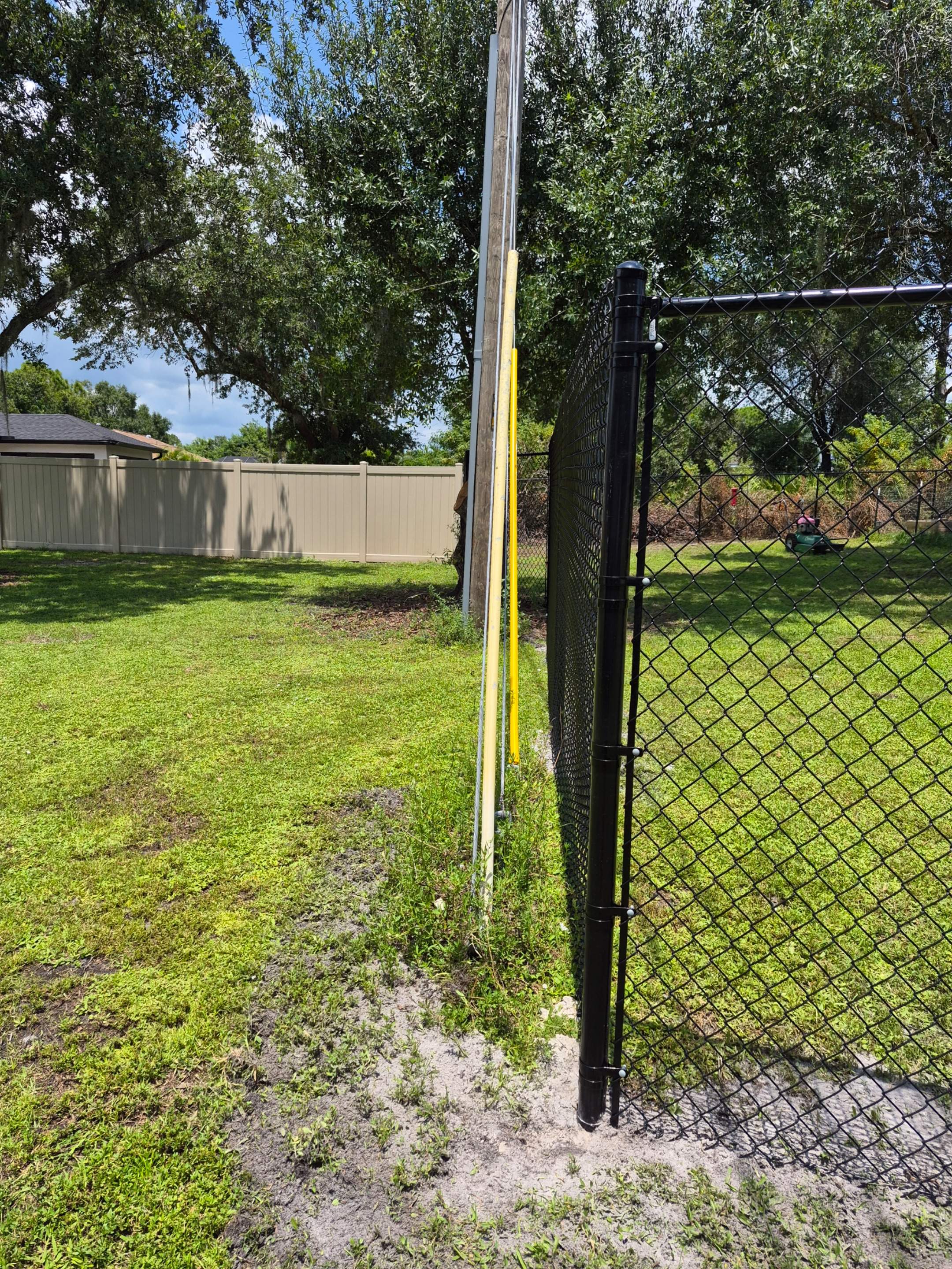 Black Chain Link Perimeter Fencing with Double Gates in Port Charlotte by True Fence LLC