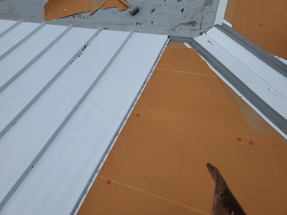 Residential Roofing Installation using 1.5" Nail Strip 24ga Solar White Kynar Coated Standing Seam Metal Panels by Morton Roofing, Inc.