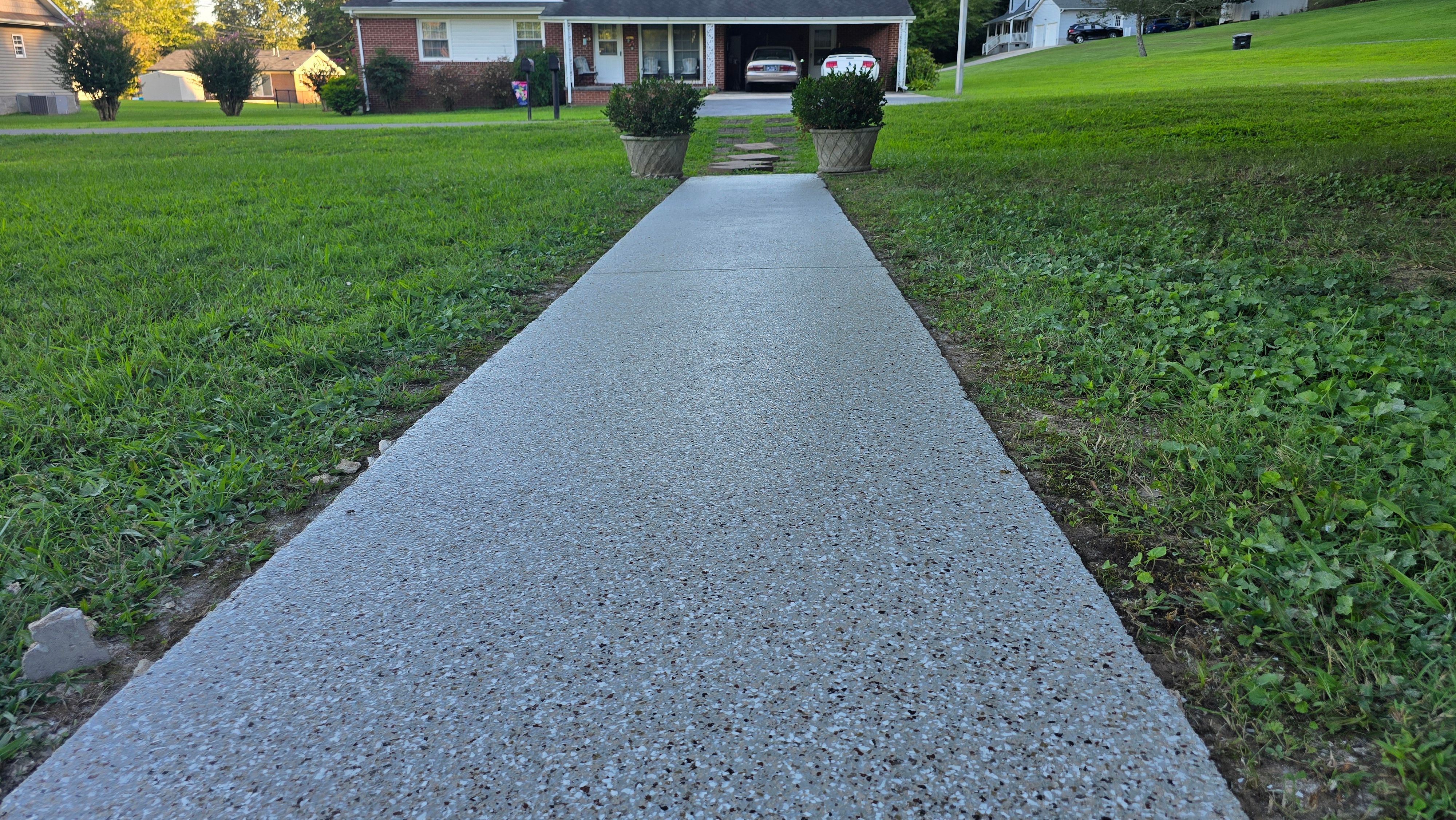 Driveway, Garage, Porch, and Sidewalk using Creekbed by Elite Floor Solutions