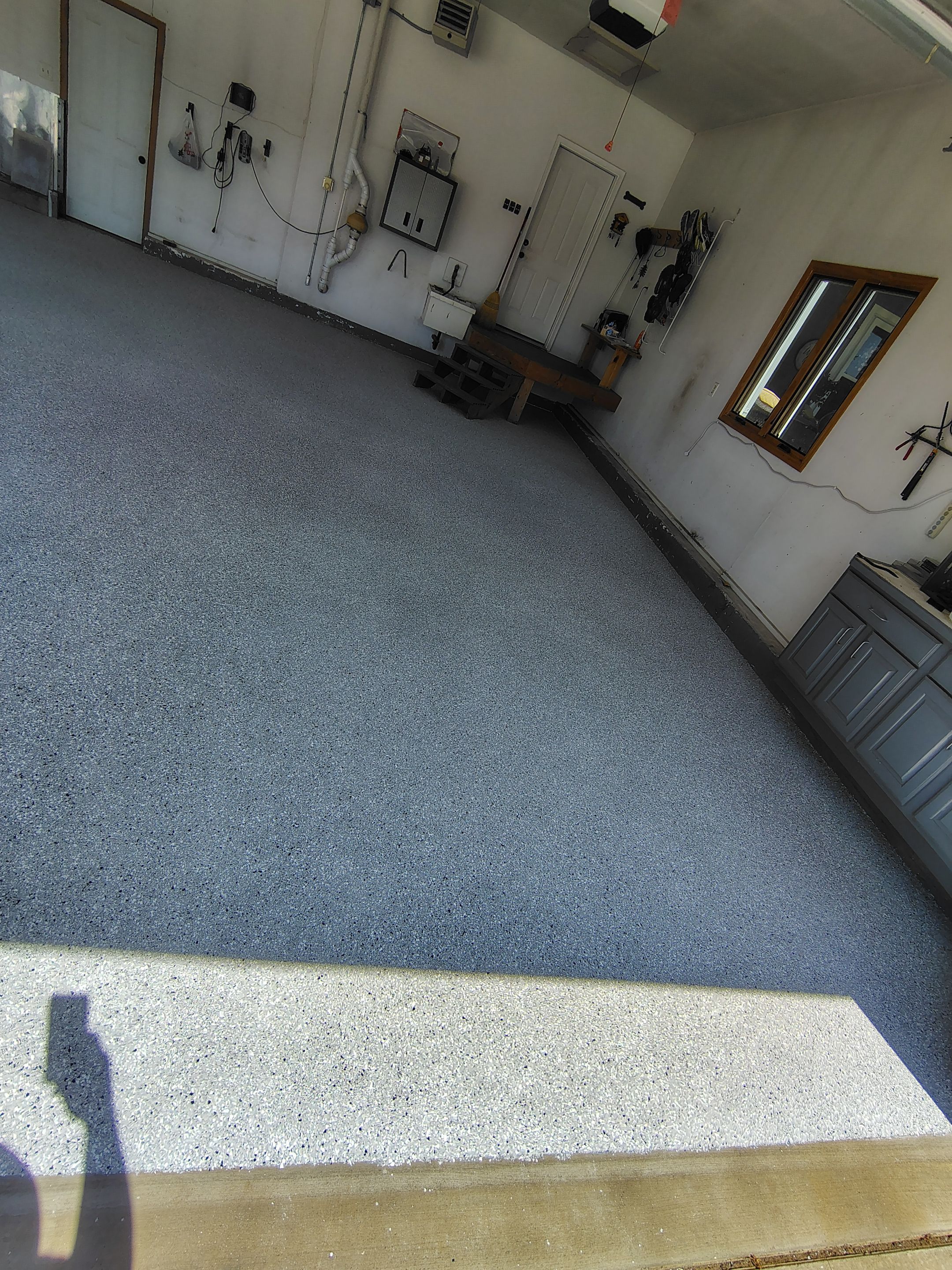 Feather Grey Garage Floor Coating Installation in Valley Springs by Select Painting, Coatings & Garage Cabinets