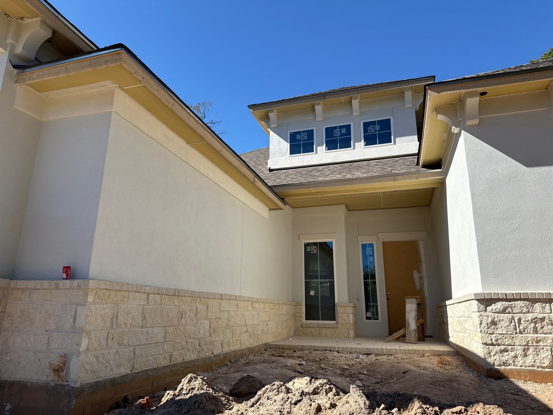 Conroe Elegance: Stucco, Foam Corbels, and Natural Stone Accents. by Apex Conventional Stucco Llc