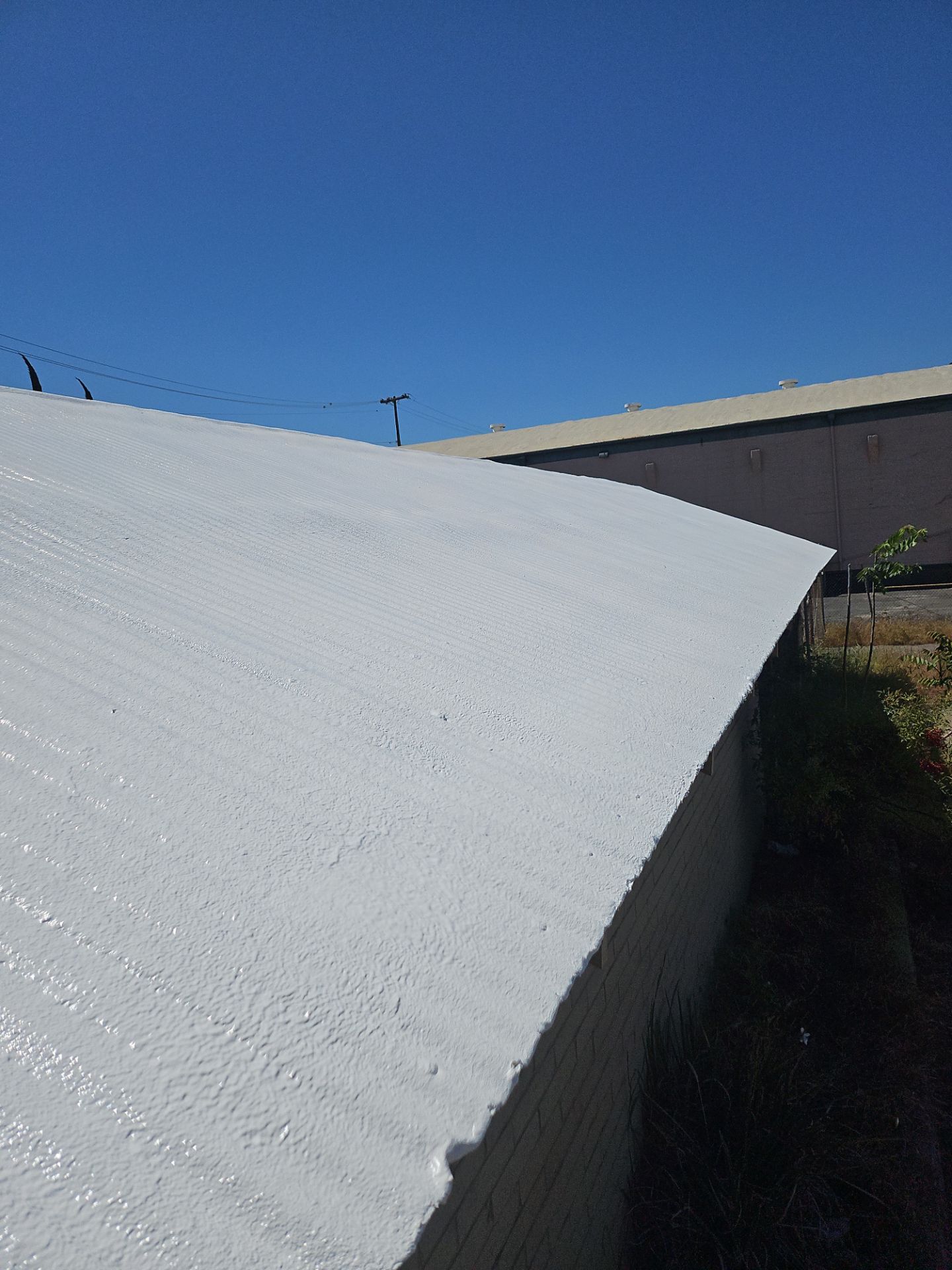 Spray foam and coatings using Conklin Benchmark/PUMA XL by Straight Edge Roofing Inc