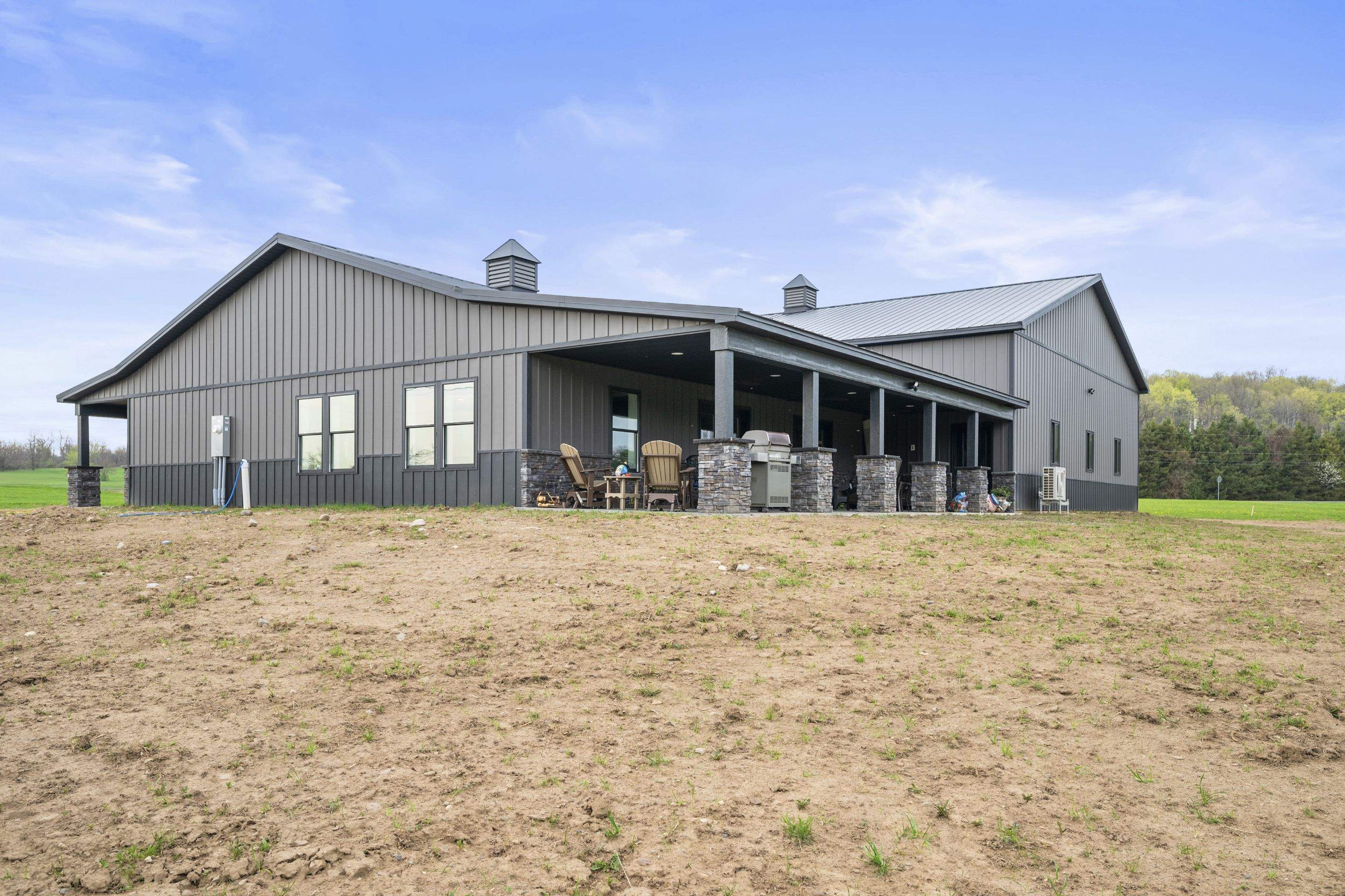 Barndominium  using Textured Board & Batton by Horst Custom Homes 