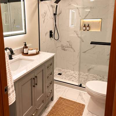Modern Bathroom Remodel with Marble Tile & Matte Black Finishes by Remodel Now