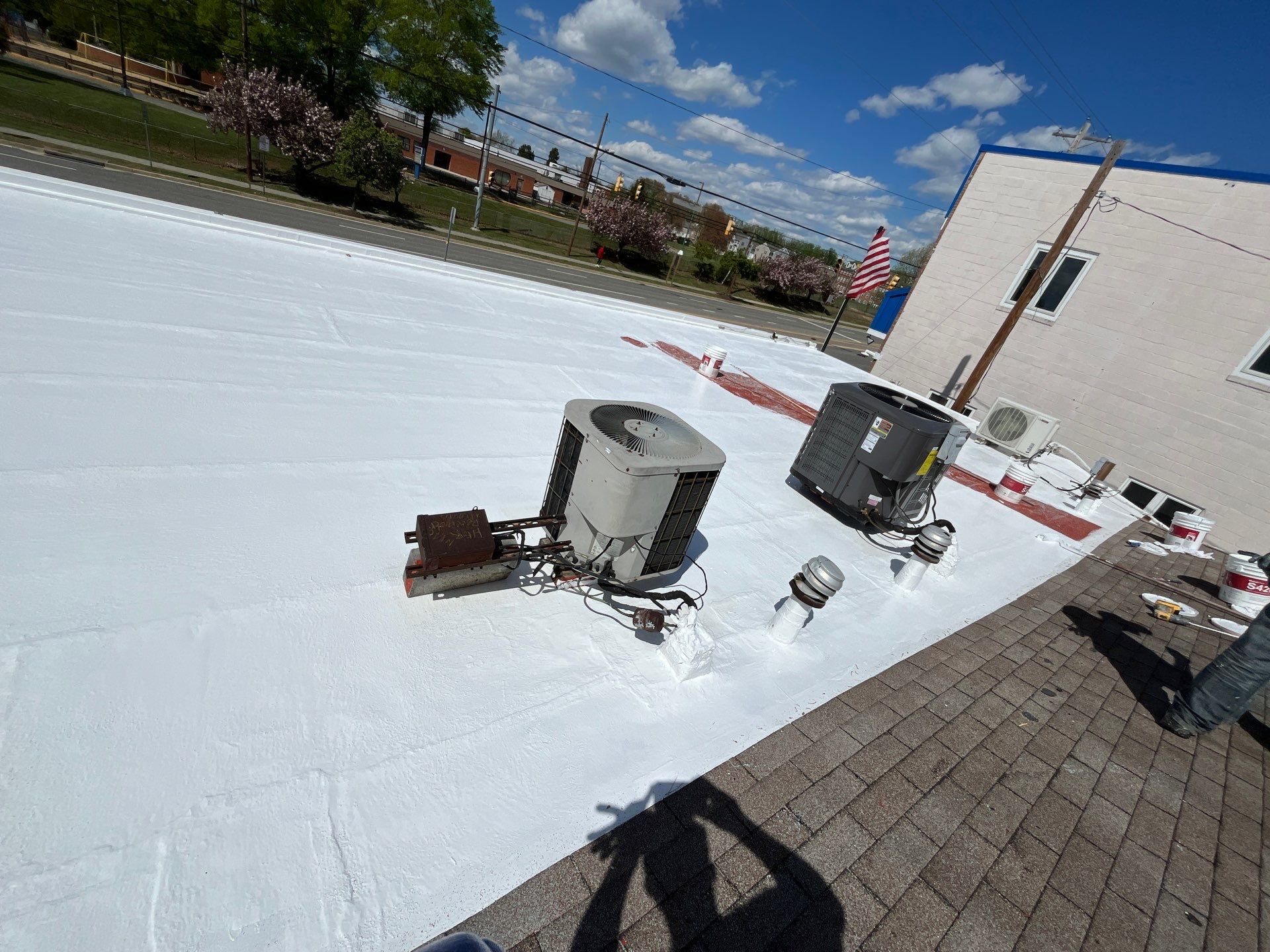 Roof Installation using Silicone Modified Flat Roof Coating by ExteriorPros