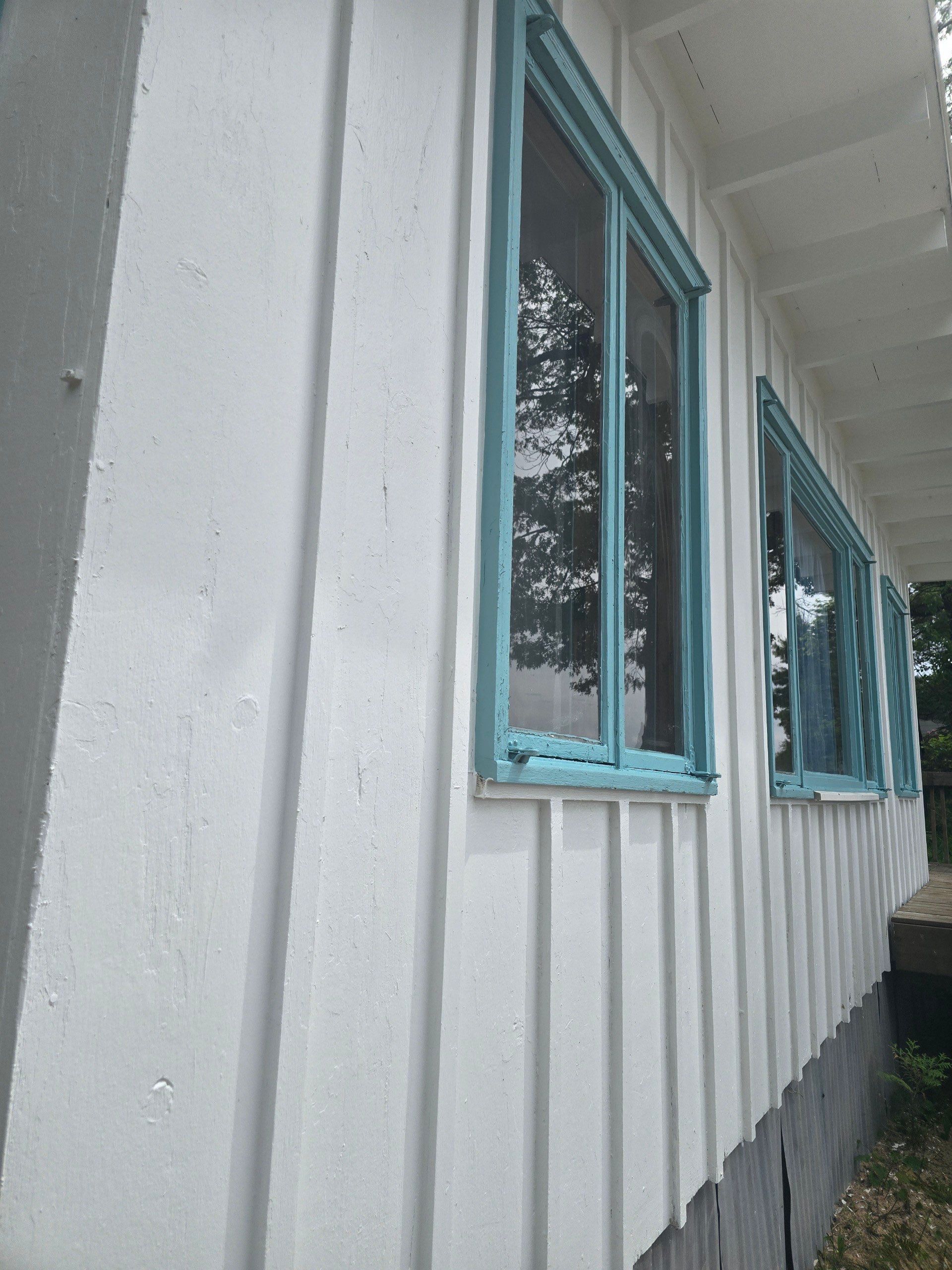Lakeside Cottage Exterior Painting and Teal Trim Restoration in Mears by Gordon Painting