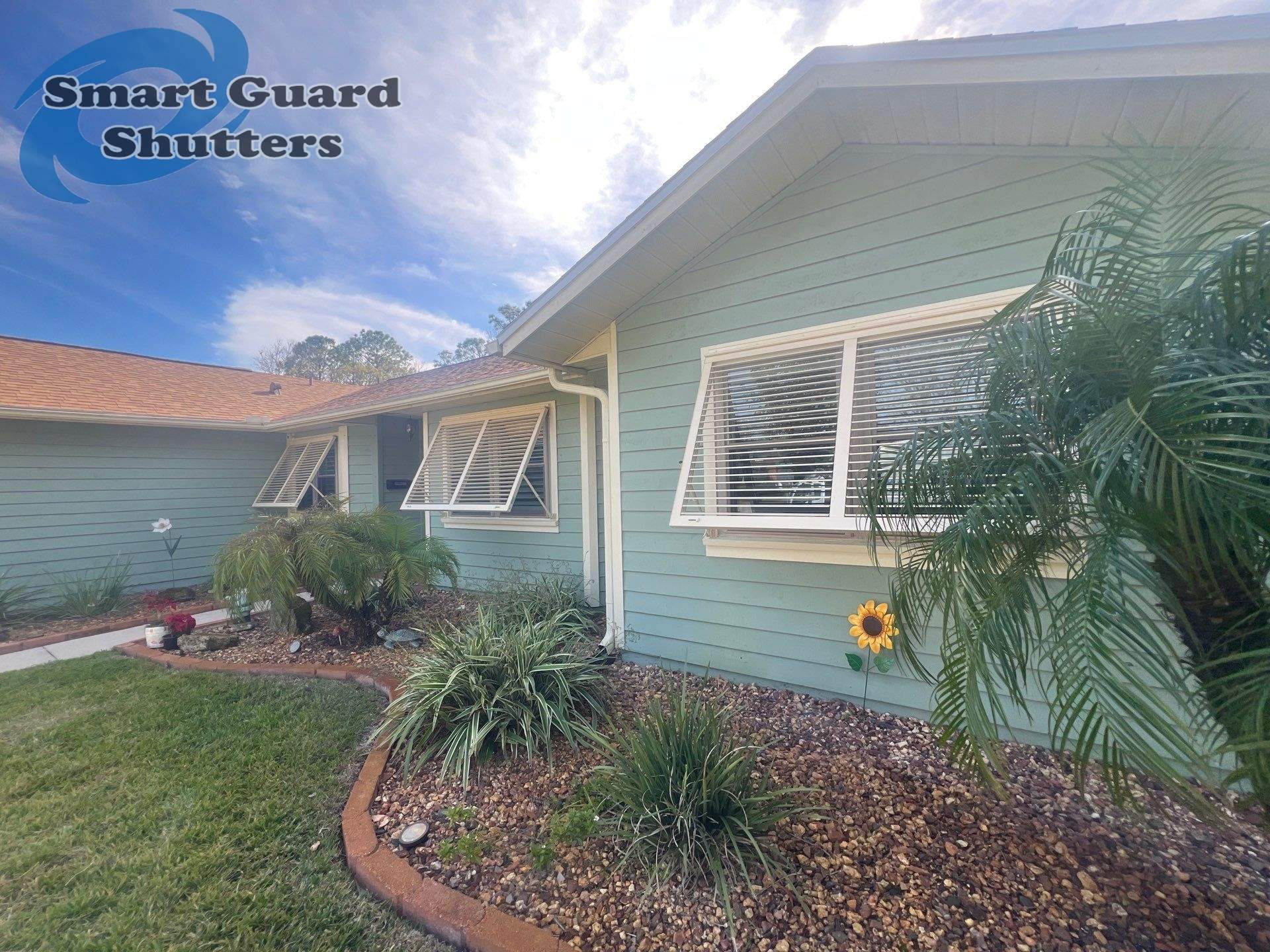 Impact Bahama Shutters in Light Ivory by Smart Guard Shutters