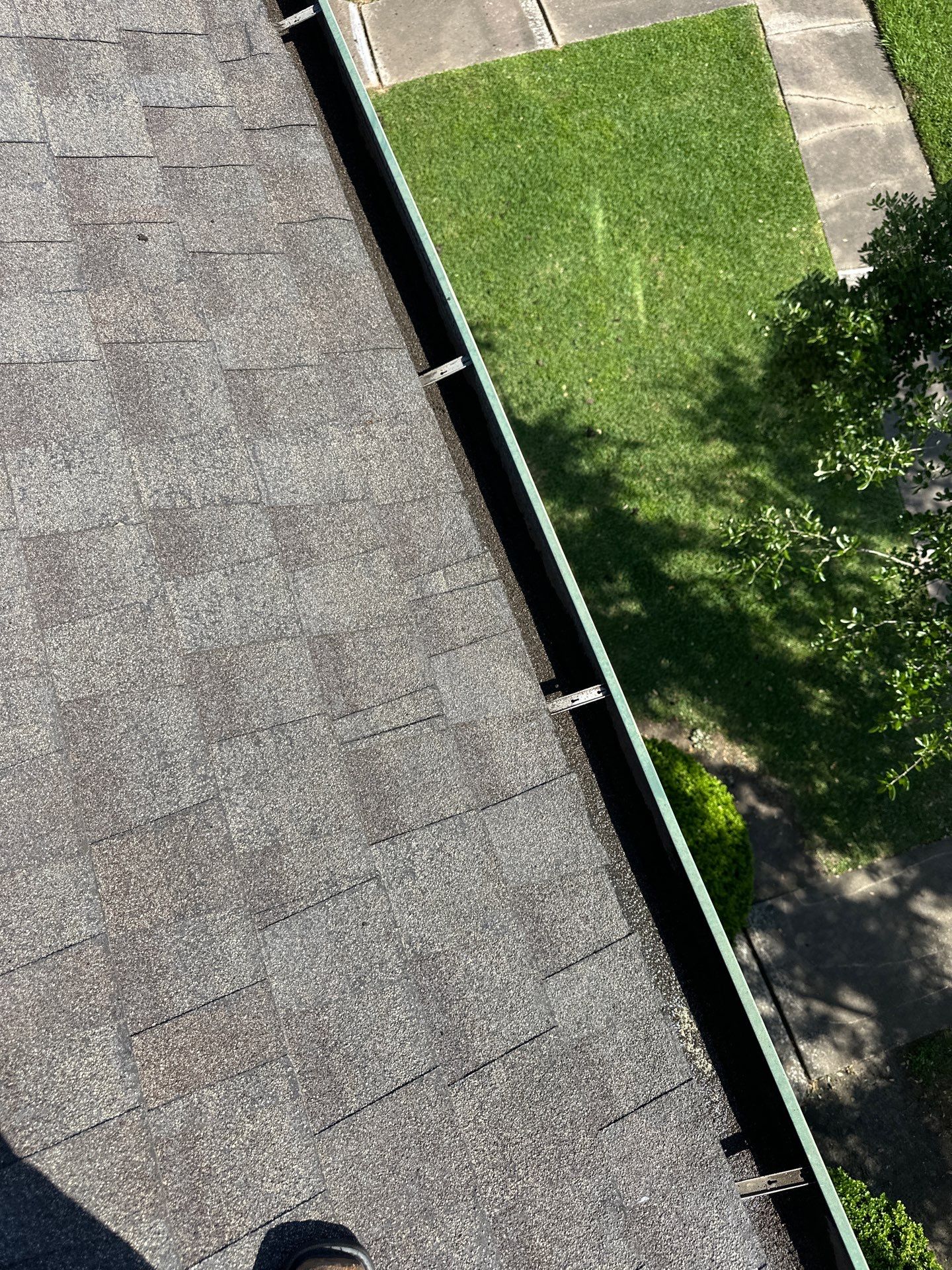 HOA gutter cleaning in Pearland, TX, after  photo showing full gutters.