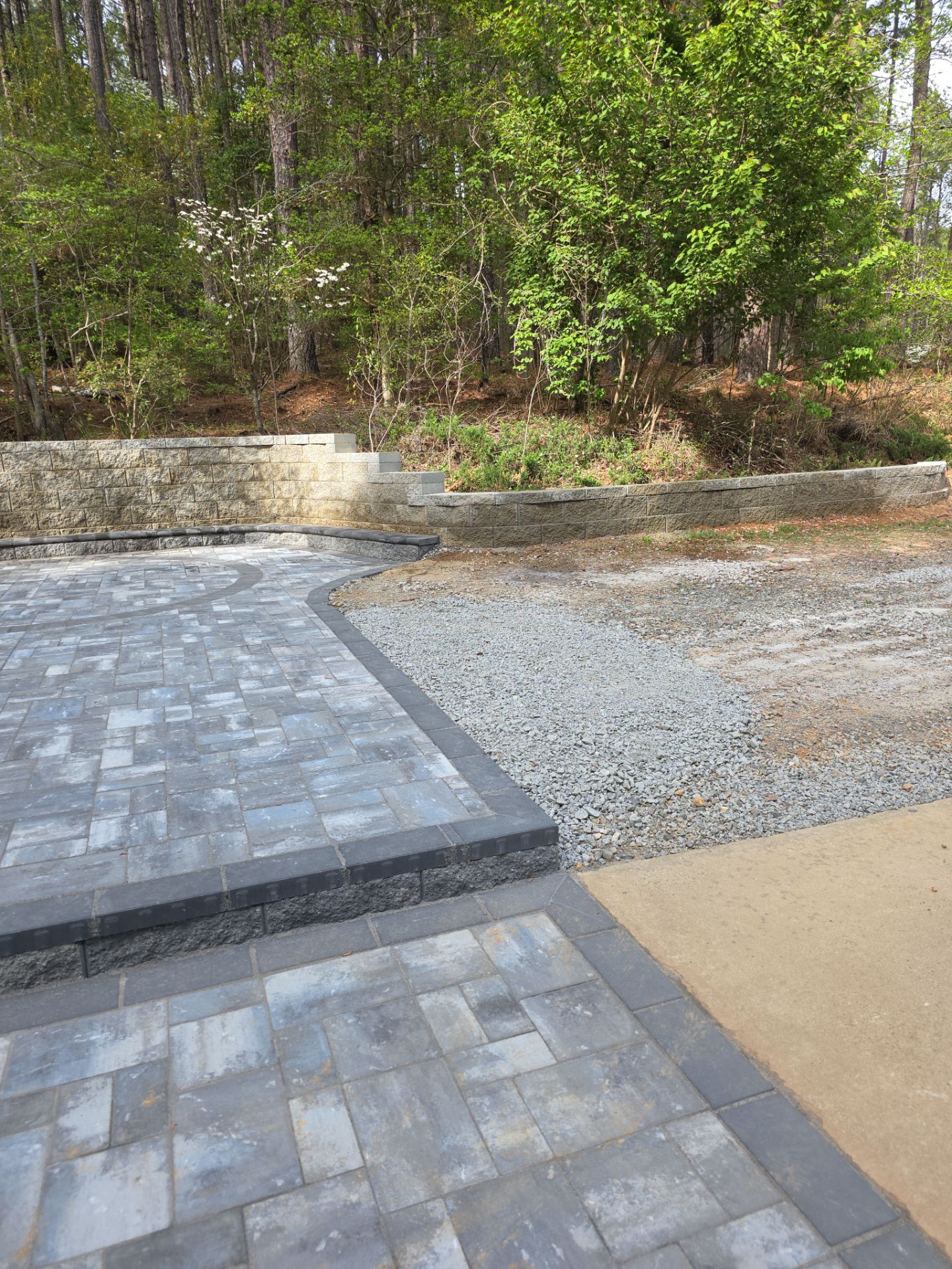 Pittsboro Outdoor Living Transformation – Retaining Wall, Paver Patio & Elevated Deck by Elite Remodeling and Design LLC