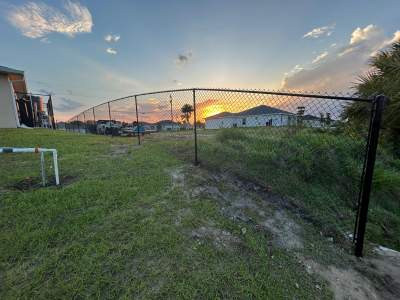 Black Chain Link Perimeter Fence and Utility Enclosure in Cape Coral