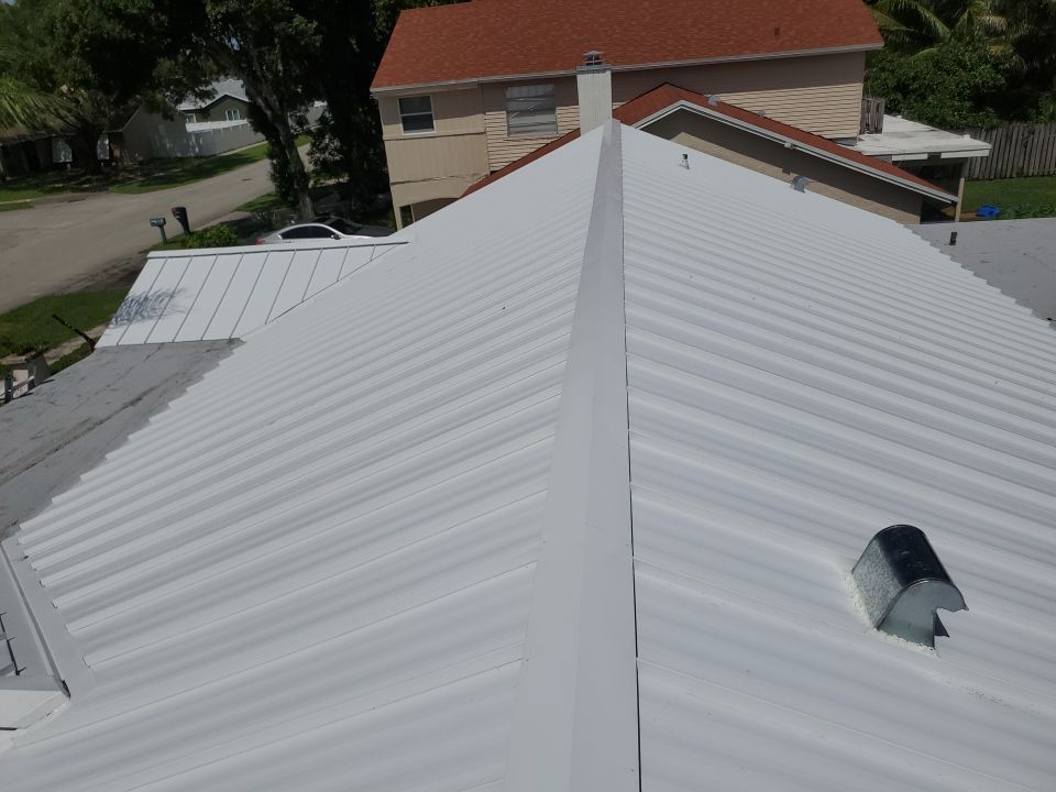 Residential Roofing Installation using 1.5" Nail Strip 24ga Solar White Kynar Coated Standing Seam Metal Panels by Morton Roofing, Inc.