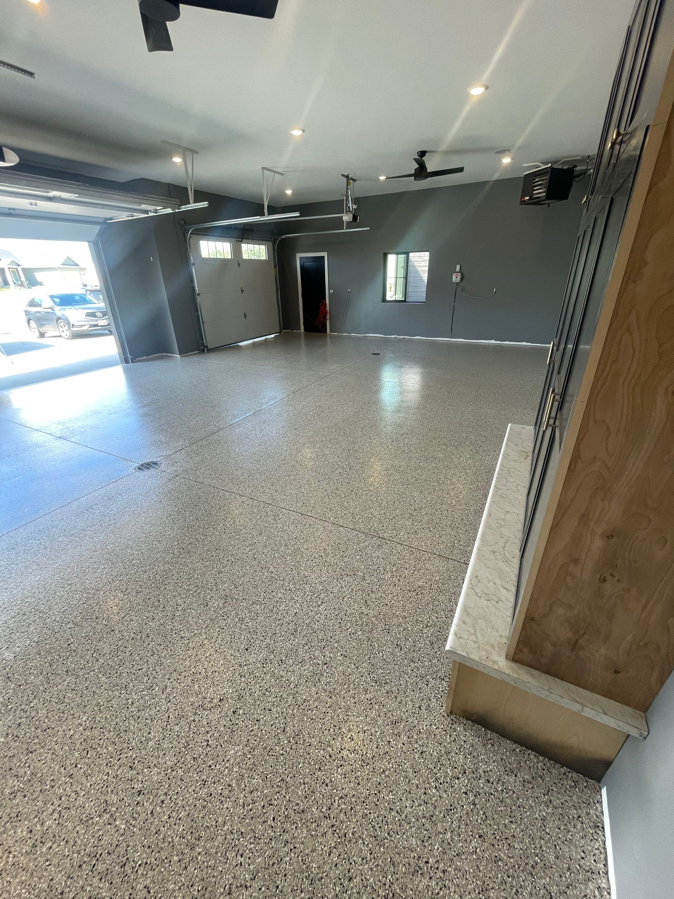 Custom Speckled Concrete Coating for Dell Rapids Garage by Select Painting, Coatings & Garage Cabinets