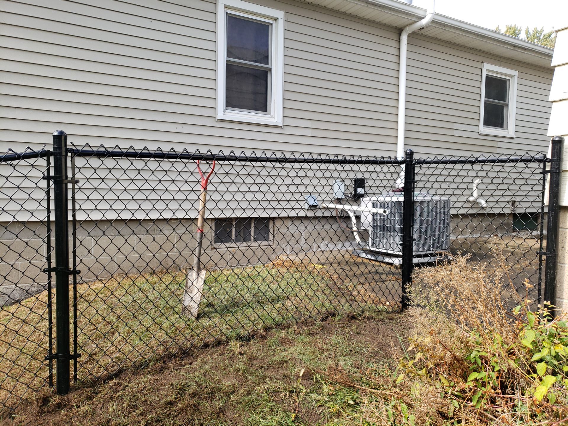 Residential Black Vinyl-Coated Chain Link Fence in Waterloo by Perfect Picket Fence and Stain