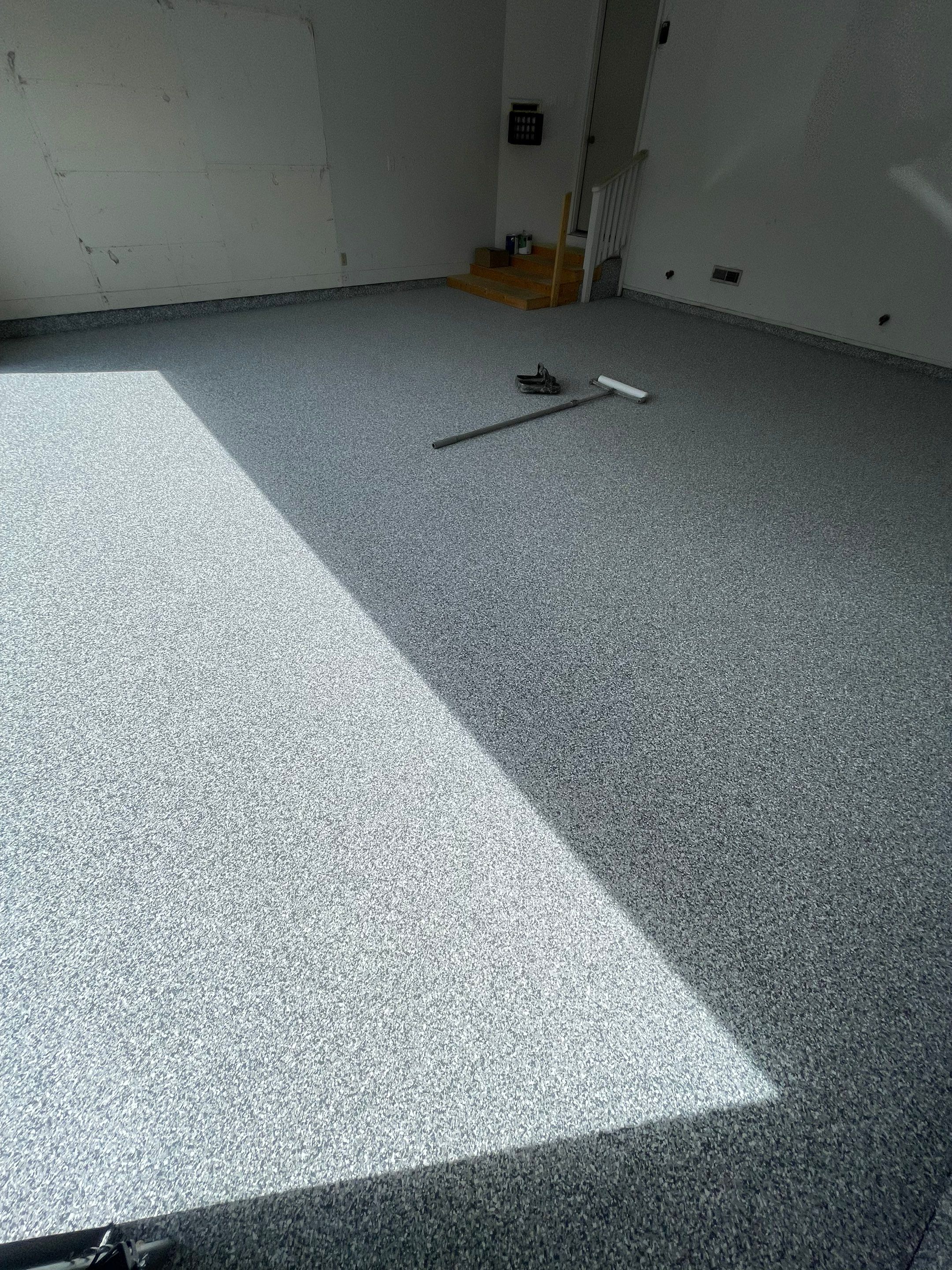 Grey Speckled Concrete Coating for Residential Garage in Yankton by Select Painting, Coatings & Garage Cabinets