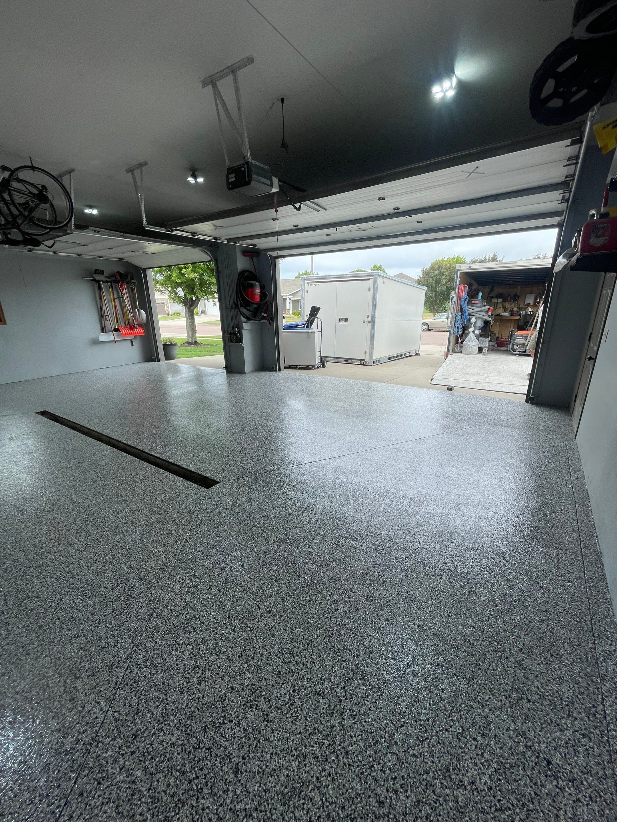 Full Garage Floor Epoxy Coating Installation in Dell Rapids by Select Painting, Coatings & Garage Cabinets