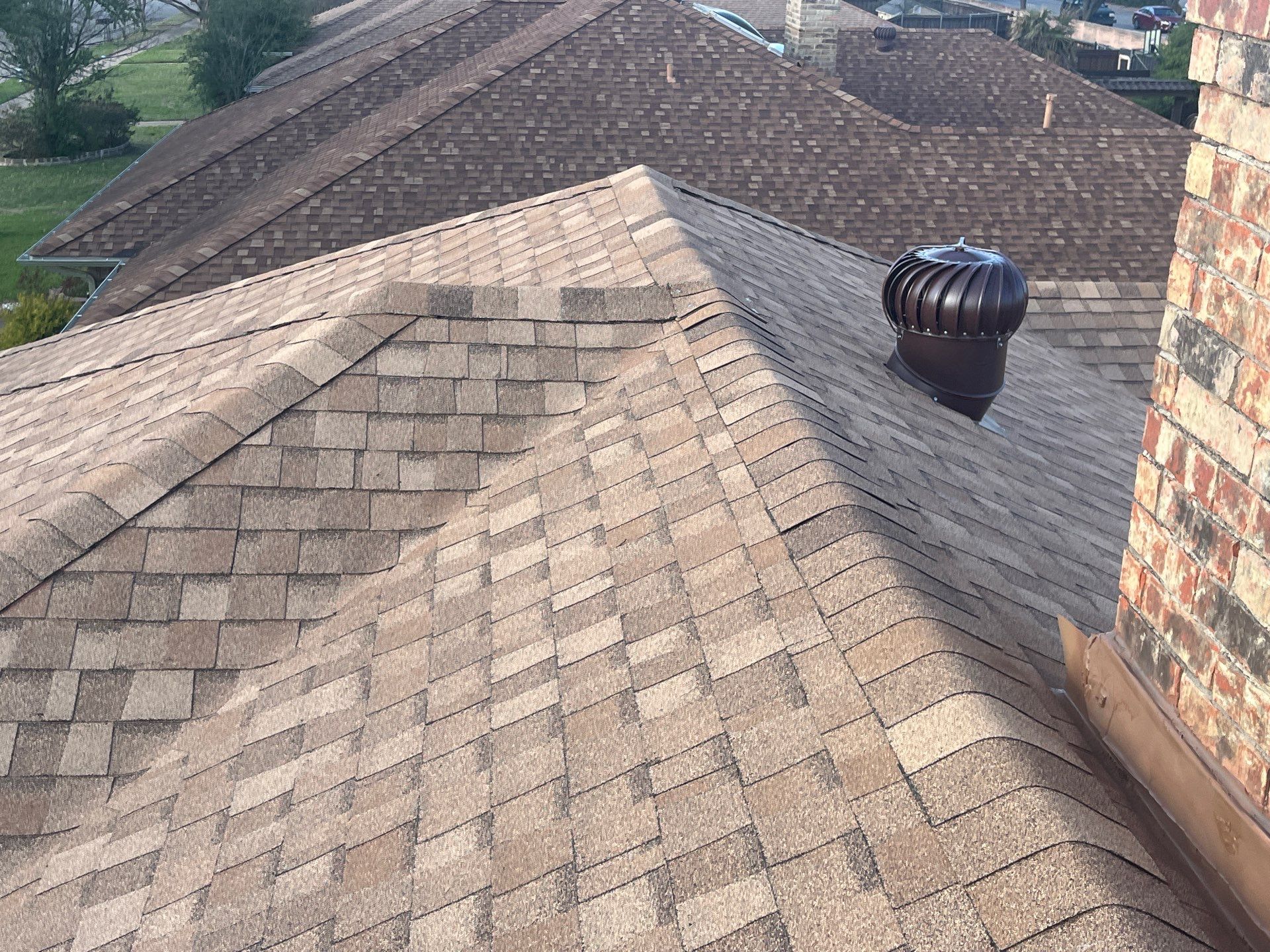 Medium brown brick with Tamko Rustic Cedar by Tejas Roofworks + Restoration