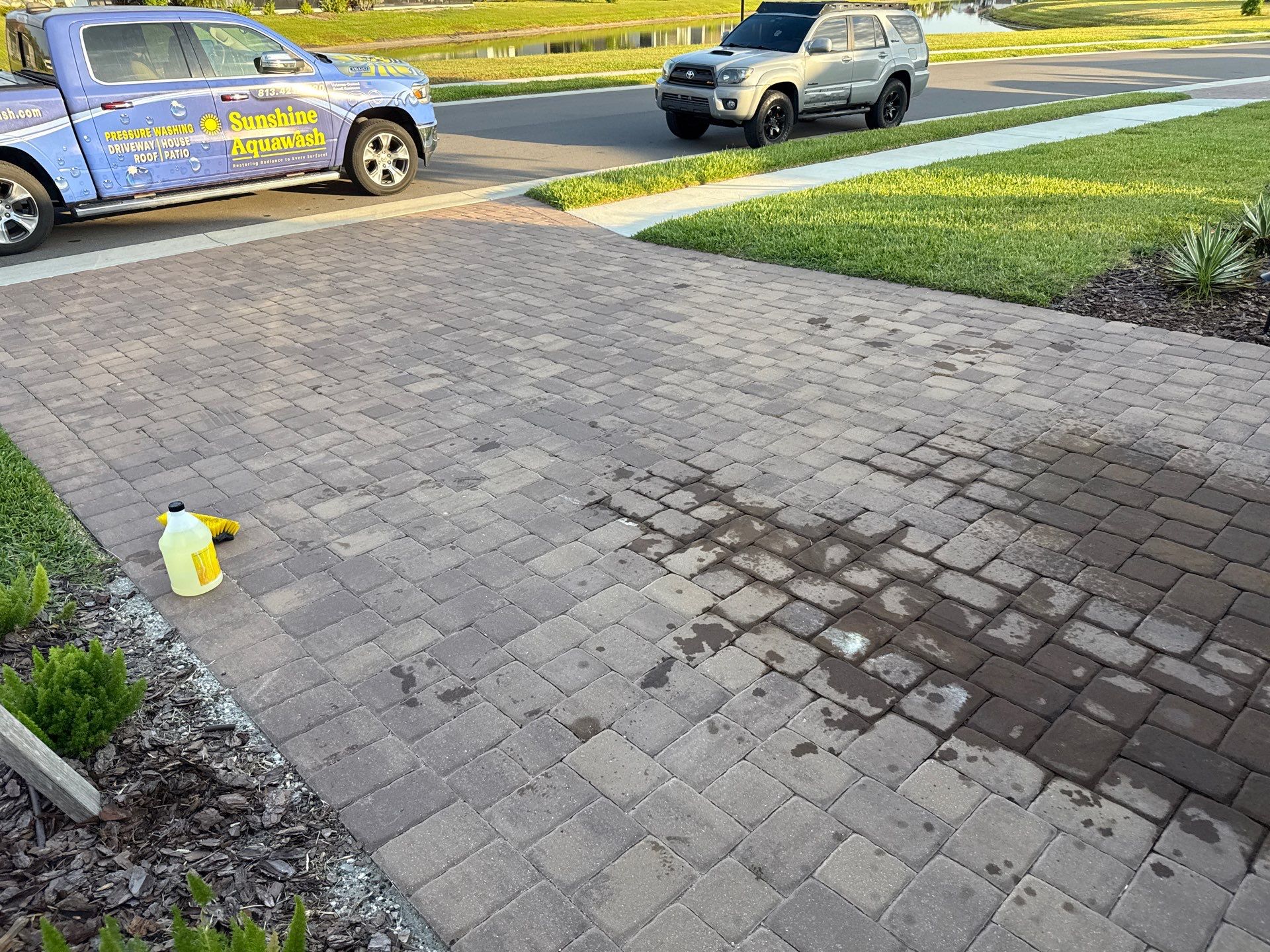 Oil Stain Removal on Paver Driveway | Esplanade at Artisan Lakes, Palmetto FL by Sunshine AquaWash