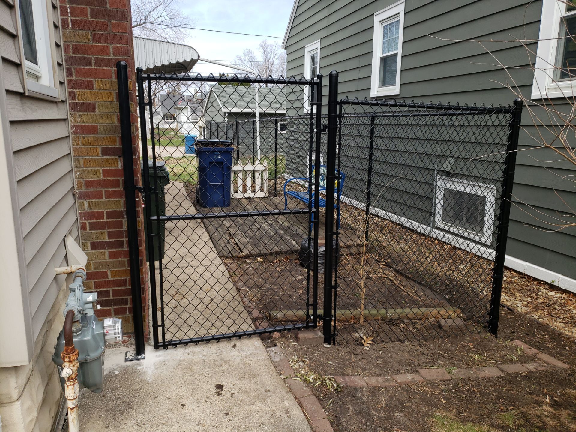 Black Vinyl Coated Chain Link Fence Installation in Waterloo by Perfect Picket Fence and Stain