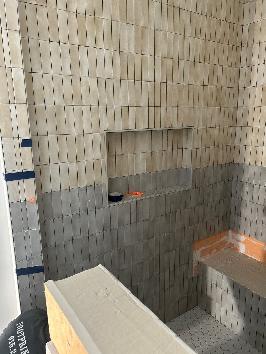 Tile floors, walls, showers, and accent wall for bathrooms  by Footprints Floors of Nashville