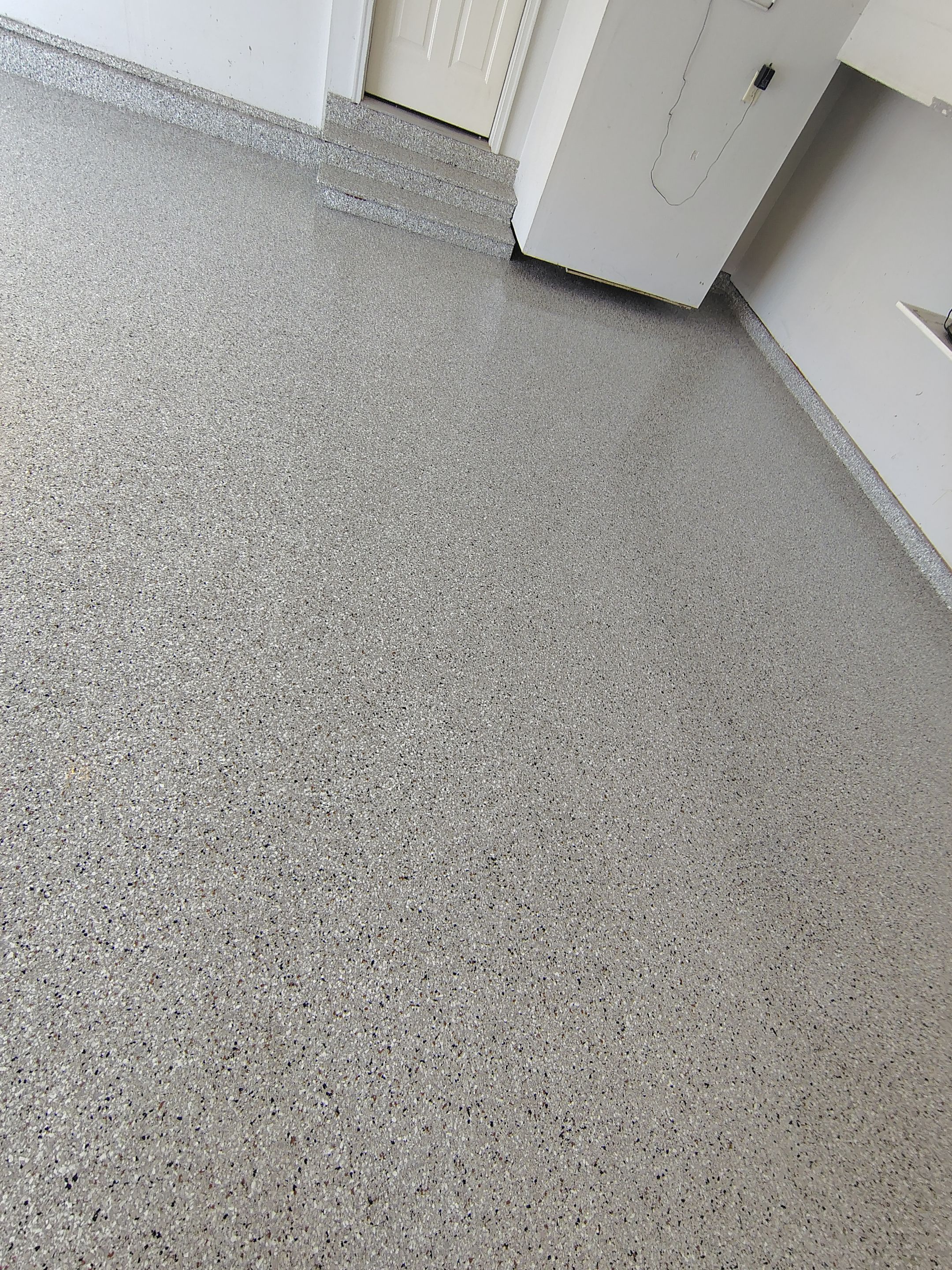 Decorative Chip Epoxy Garage Floor Coating in Sioux Falls by Select Painting, Coatings & Garage Cabinets