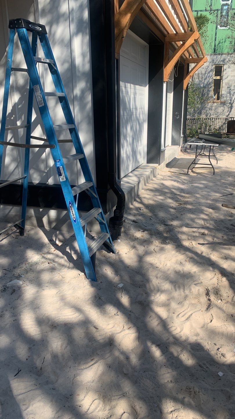Seamless Gutter Installation Using Black Half Round Seamless Gutters by Gutter Professors