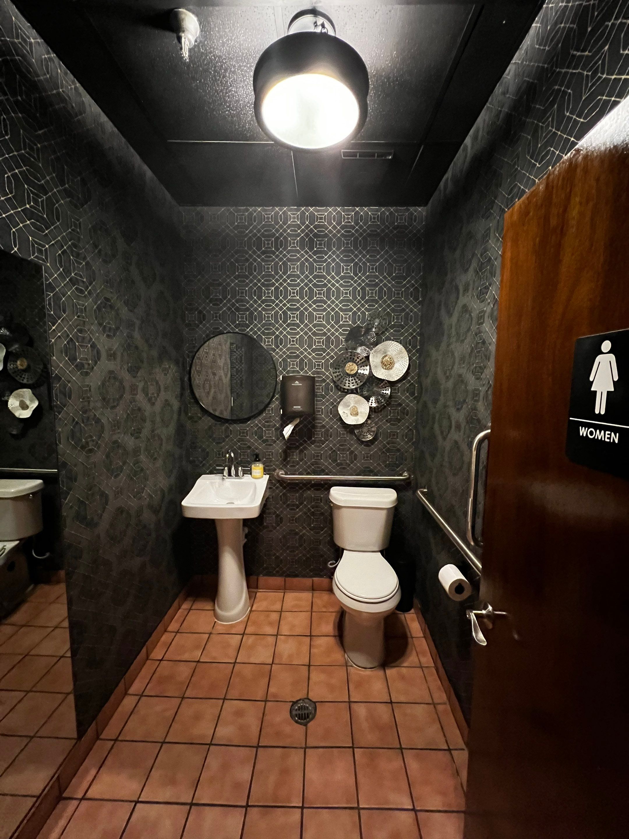 Commercial Restaurant Restroom Renovation Featuring Patterned Wallpaper in Smyrna by Swift Home Renovations