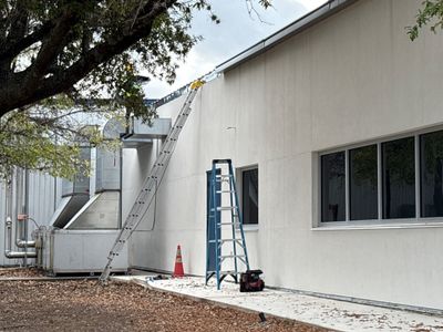 Exterior view of building with metal roof and ladder