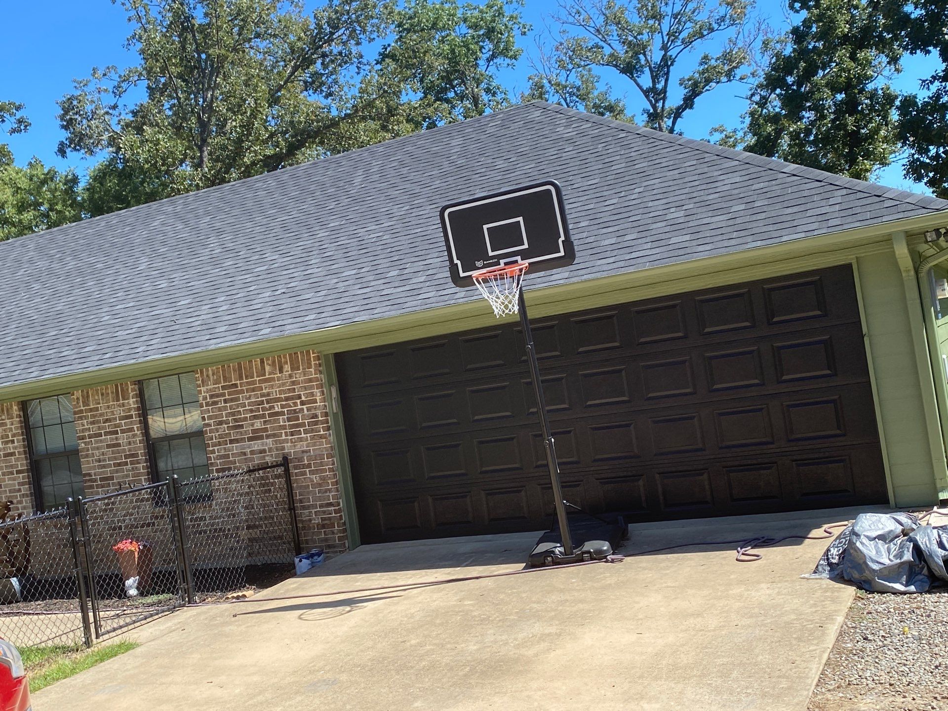 Exterior Repaint – Tyler, Texas - Bold green color with black garage by Quality Coats Painting