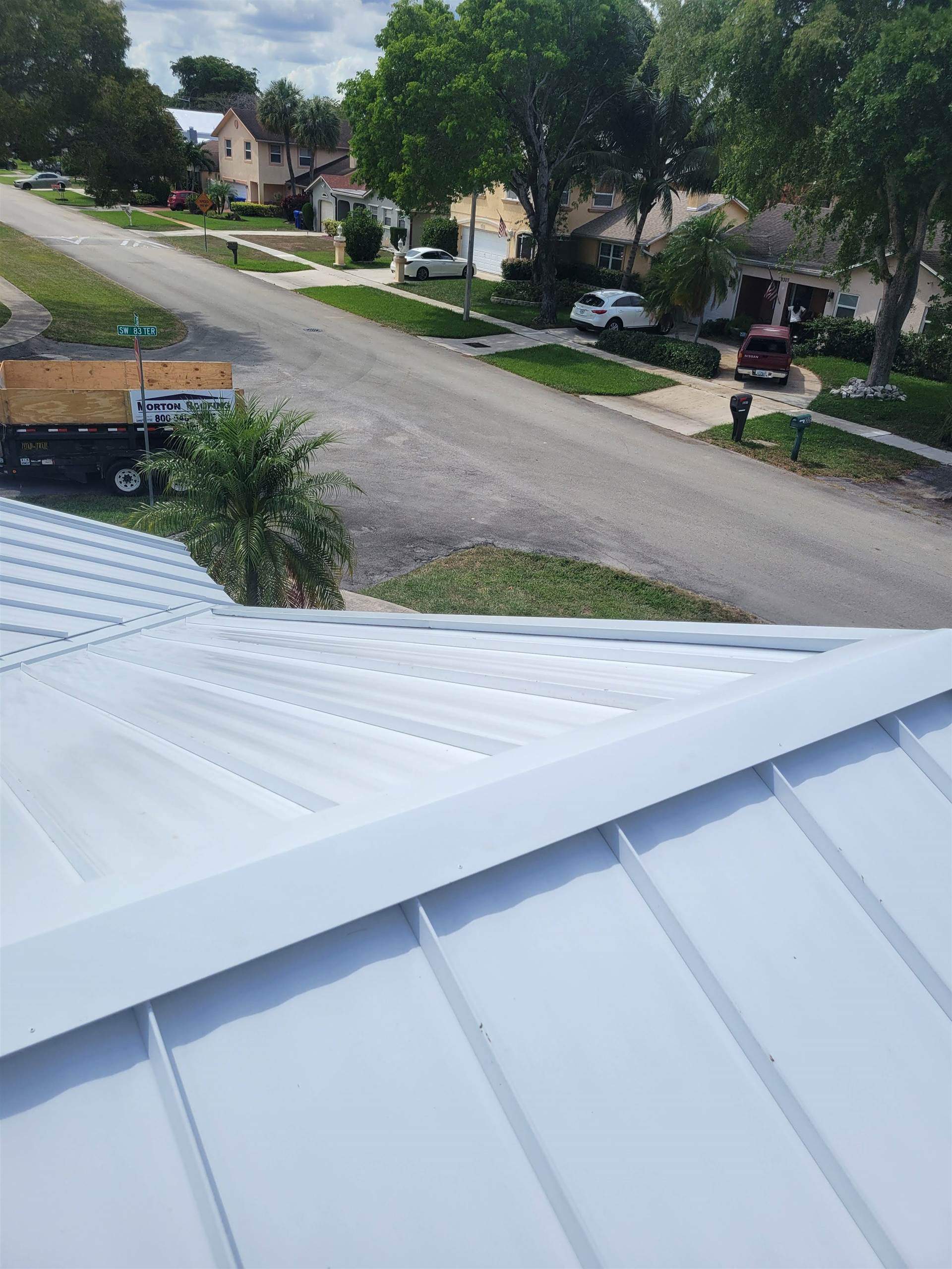 Standing Seam Metal & Flat Re-Roof using 1.5" Nail Strip 24ga Solar White Kynar Coated Standing Seam Metal Panels by Morton Roofing, Inc.