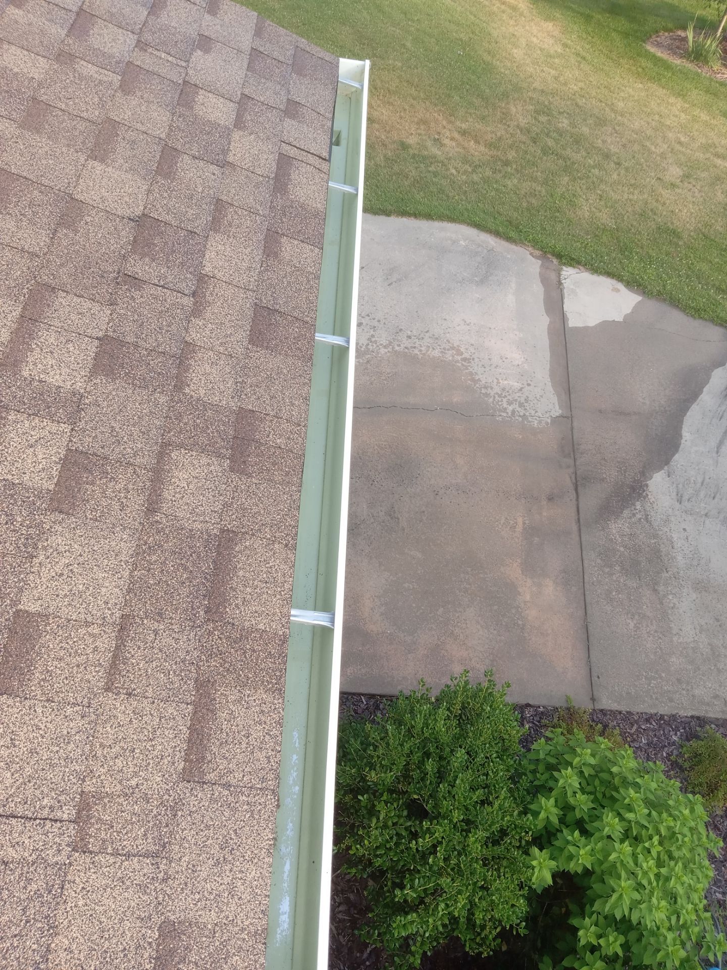 pressure washing driveway and sidewalk to remove dirt buildup restoring appearance