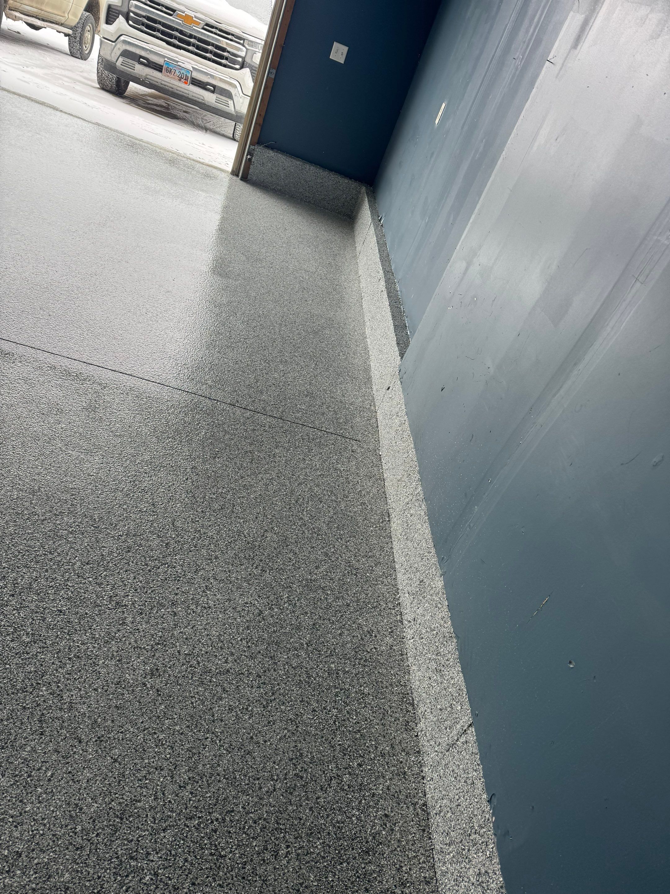 Grey Speckled Epoxy Garage Floor and Stair Coating in Sioux Falls by Select Painting, Coatings & Garage Cabinets