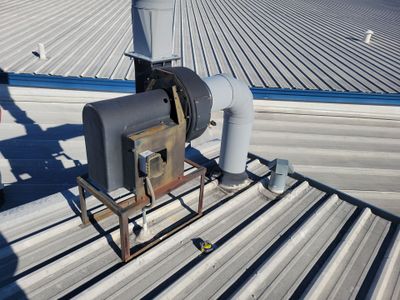 Wide view of standing seam metal roof with equipment