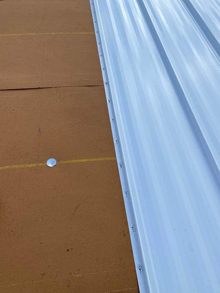 Standing Seam Metal & Flat Re-Roof using 1.5" Nail Strip 24ga Solar White Kynar Coated Standing Seam Metal Panels by Morton Roofing, Inc.