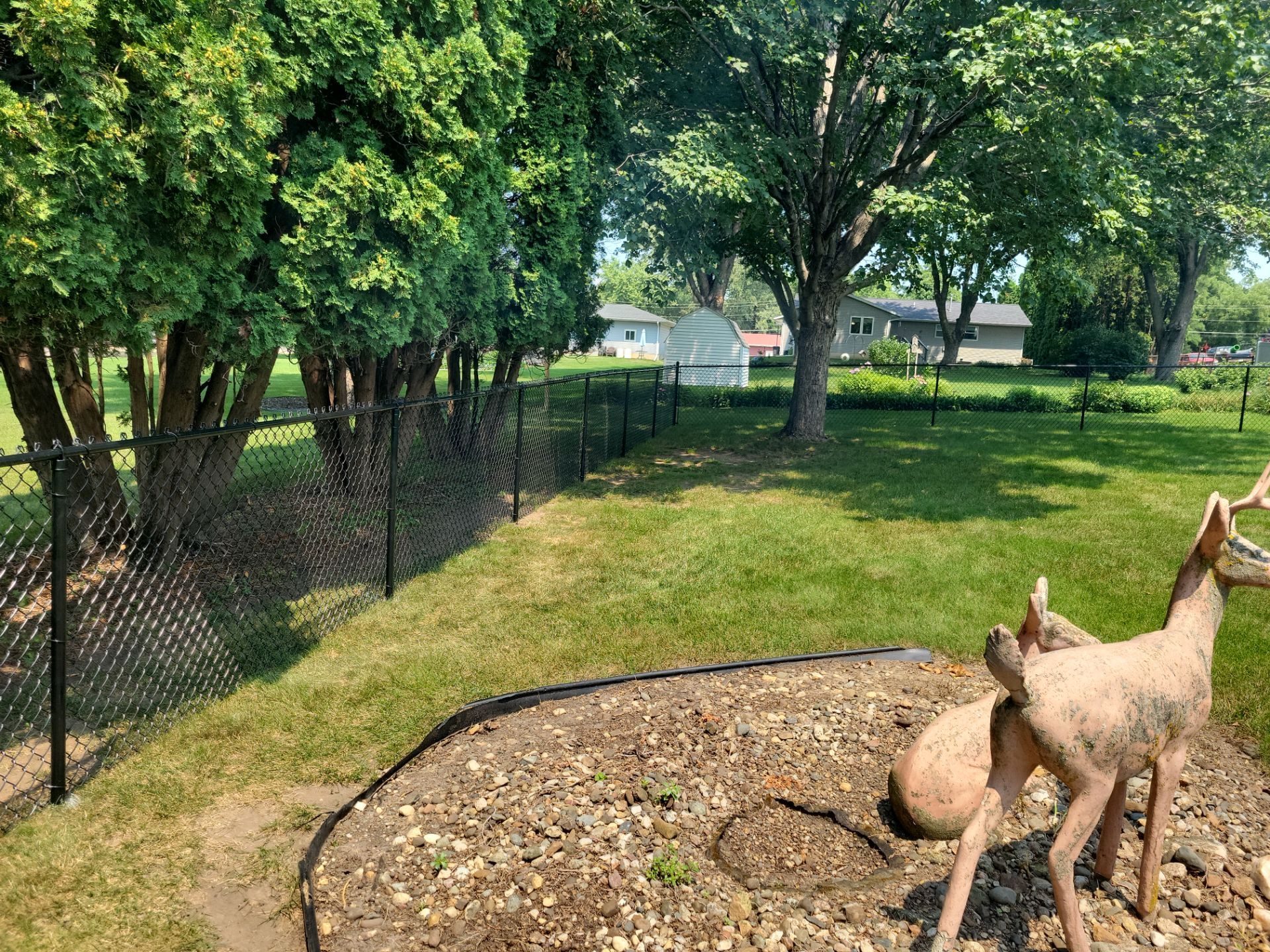 Black Vinyl-Coated Chain Link Fence Installation in New Hampton by Perfect Picket Fence and Stain
