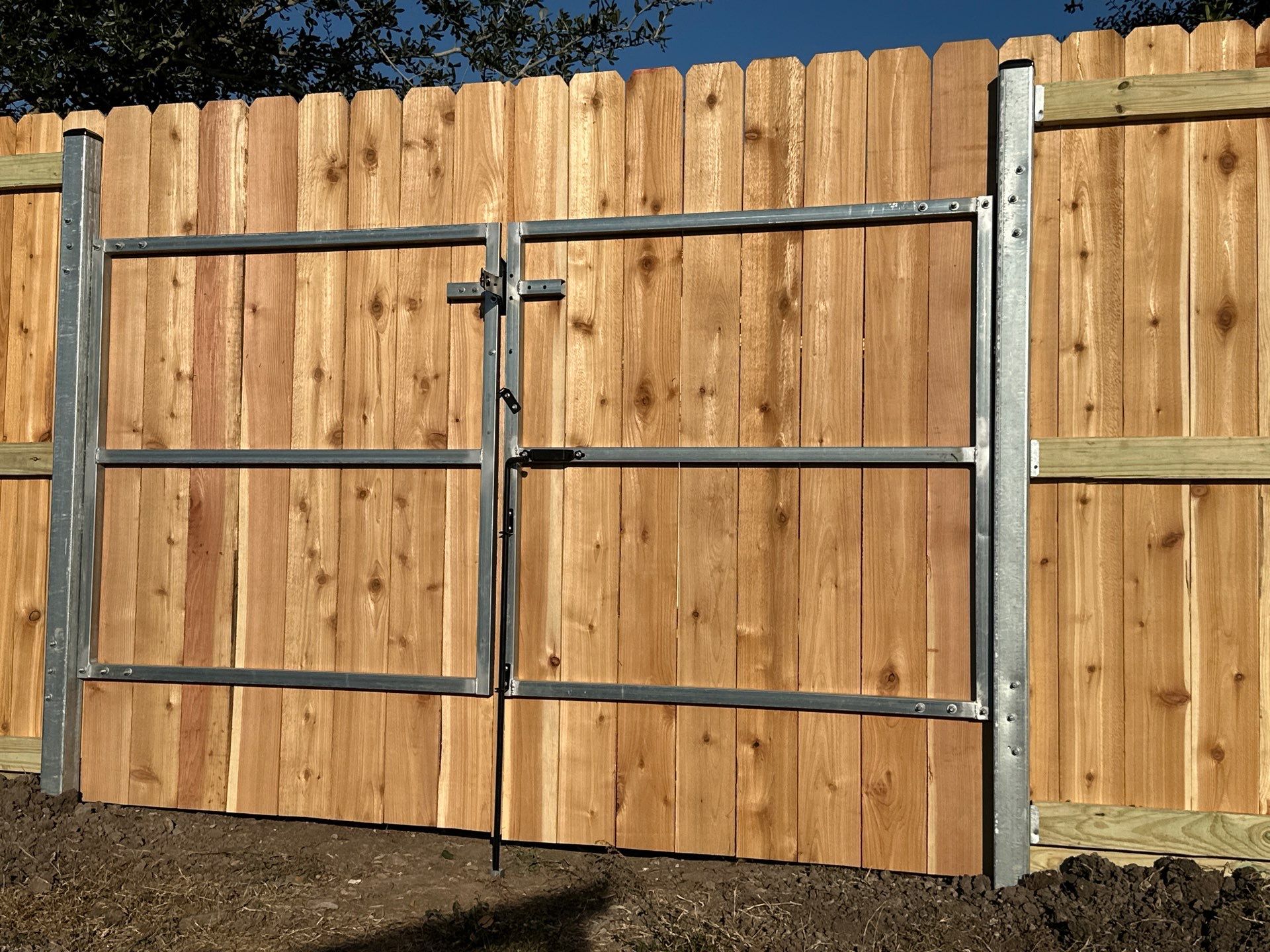 Beautiful Wood fence with metal posts by Tim's Fences