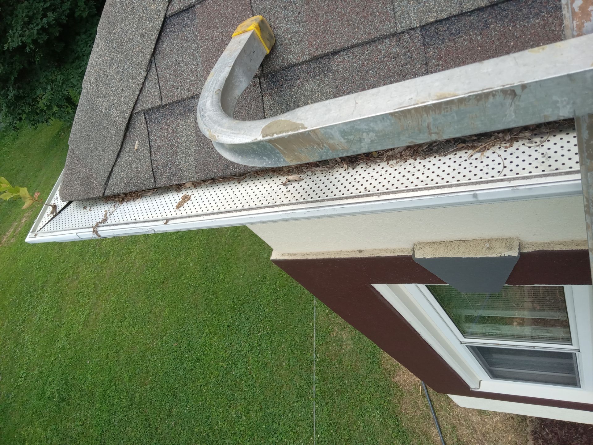 the image shows a residential gutter and soffit the pressure washing company based in kernersville nc is likely providing a service to clean the exteriors of gutters to remove dirt debris and algae buildup they may also be cleaning the soffit which is the underside area of the roof overhang to enhance the appearance and maintain the integrity of the structure