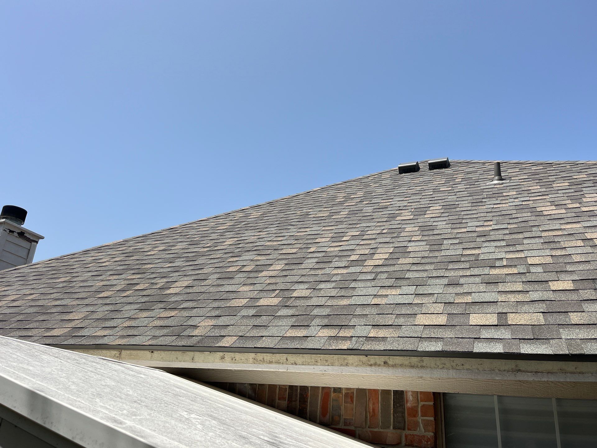 Red brick with IKO Cornerstone  by Tejas Roofworks + Restoration