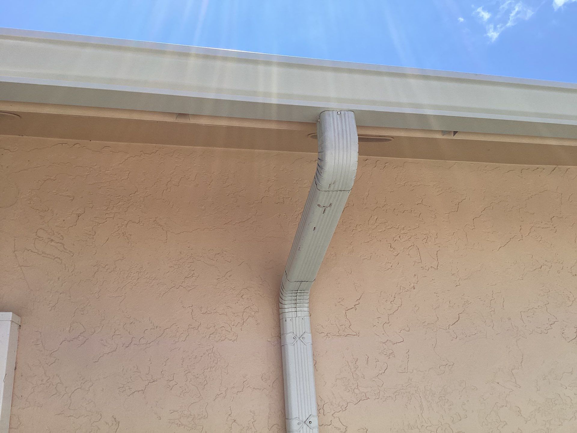 White K Style Seamless Gutters using 3X4 Elbow Downspout in Cape Coral FL by Gutter Professors