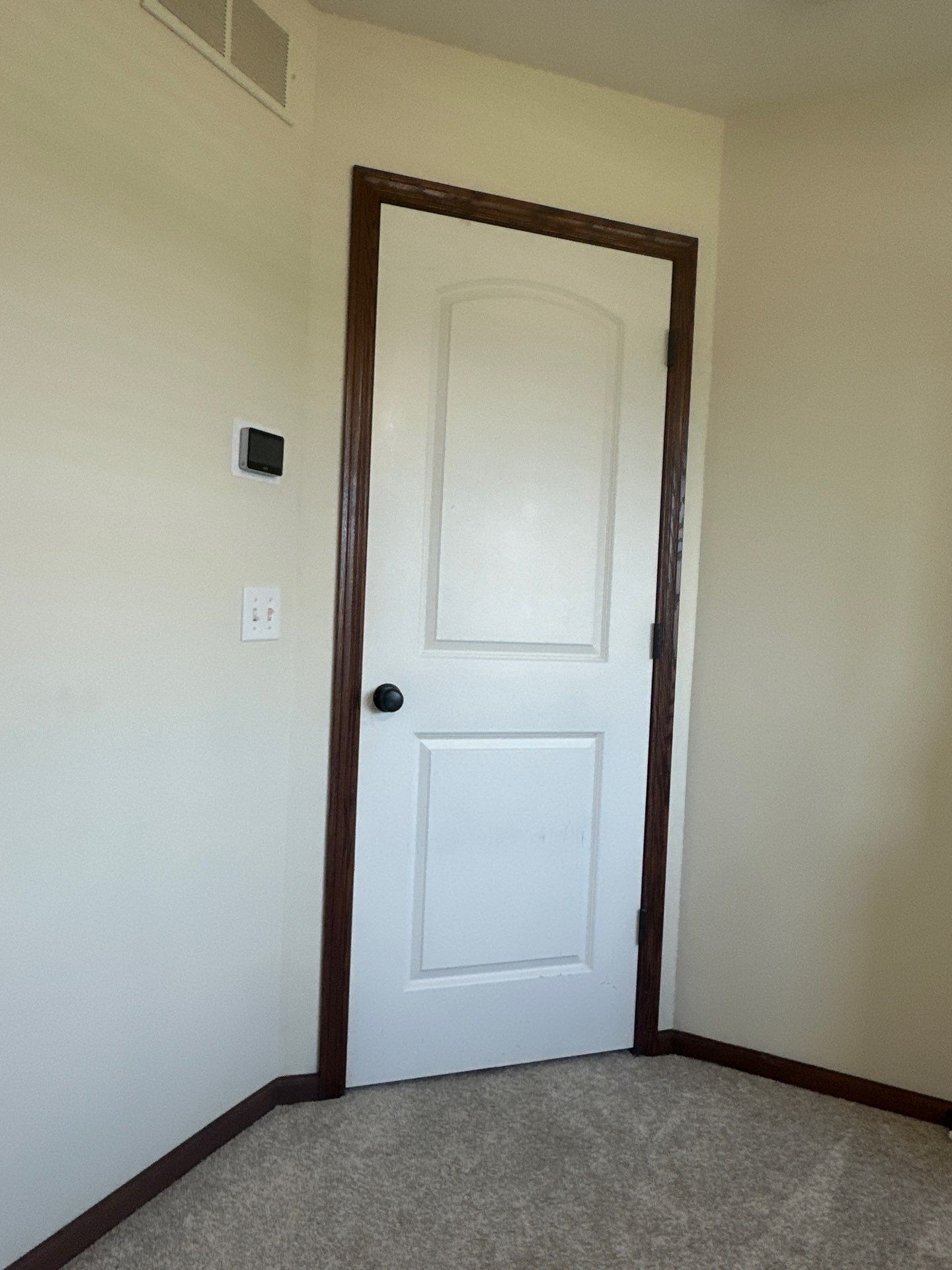 Interior White Door and Dark Wood Trim Installation in Lincoln by CompanyCam Sales Demo