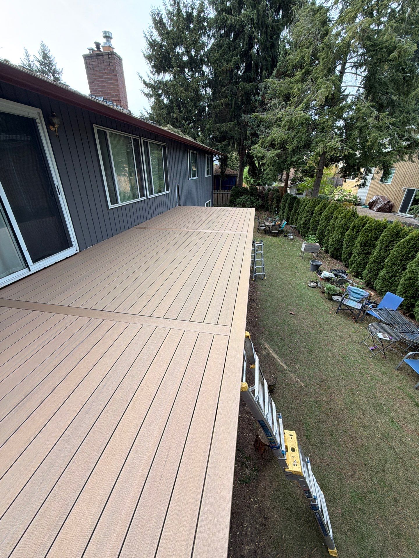 Elevated TimberTech Composite Deck Replacement With Black Metal Railings by Emerald City Energy