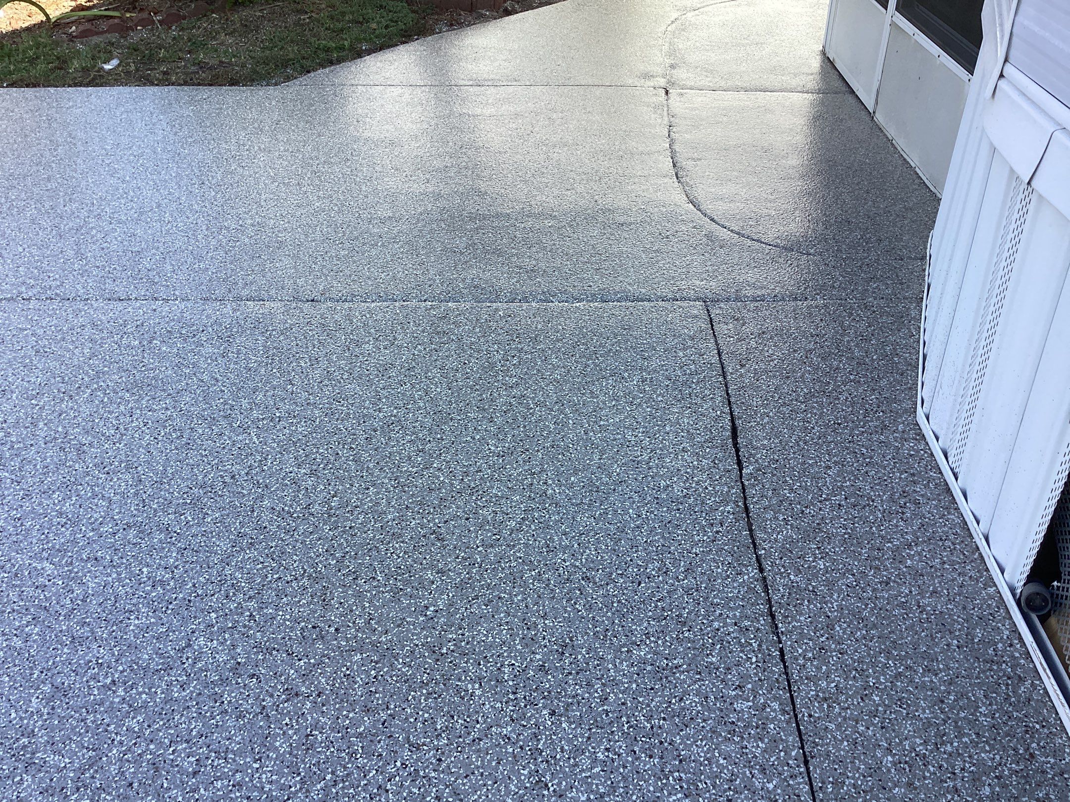 Driveway using Pebble Beach by Amvet concrete coatings llc