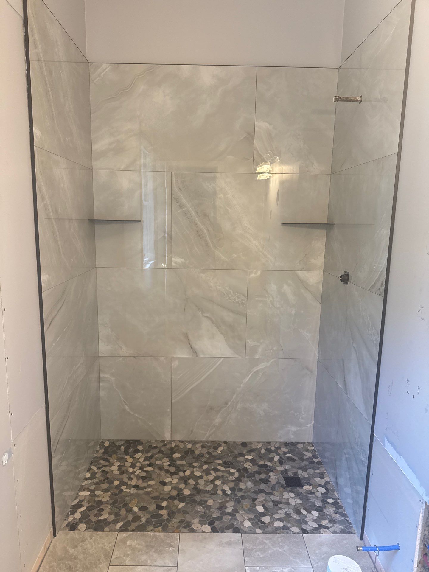 Marietta Bathroom Remodel with Marble Tile and Pebble Floor by Swift Home Renovations