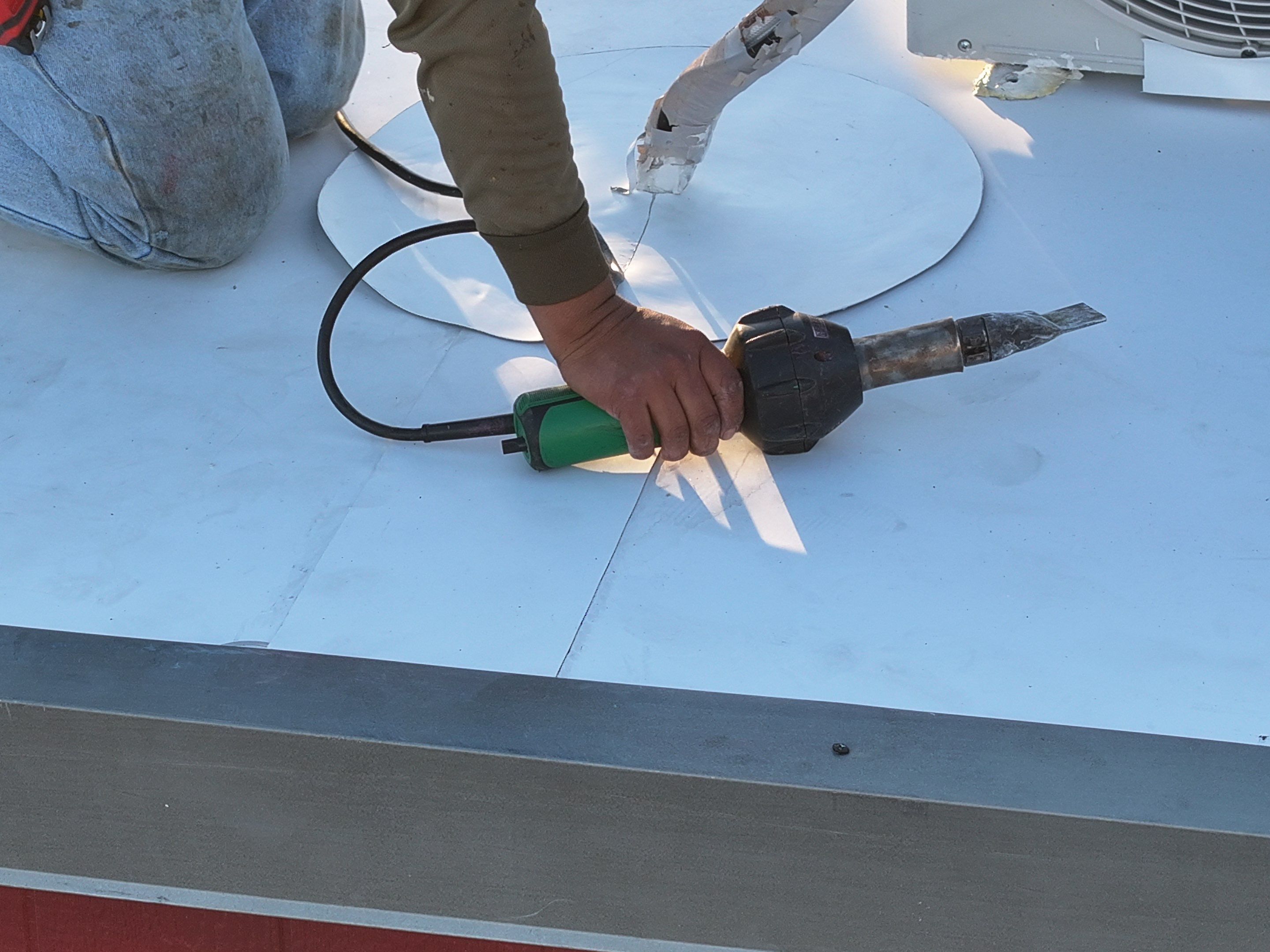 Commercial roofing overlay using GAF TPO over an old ballast roof by Becker Roofing and Exteriors