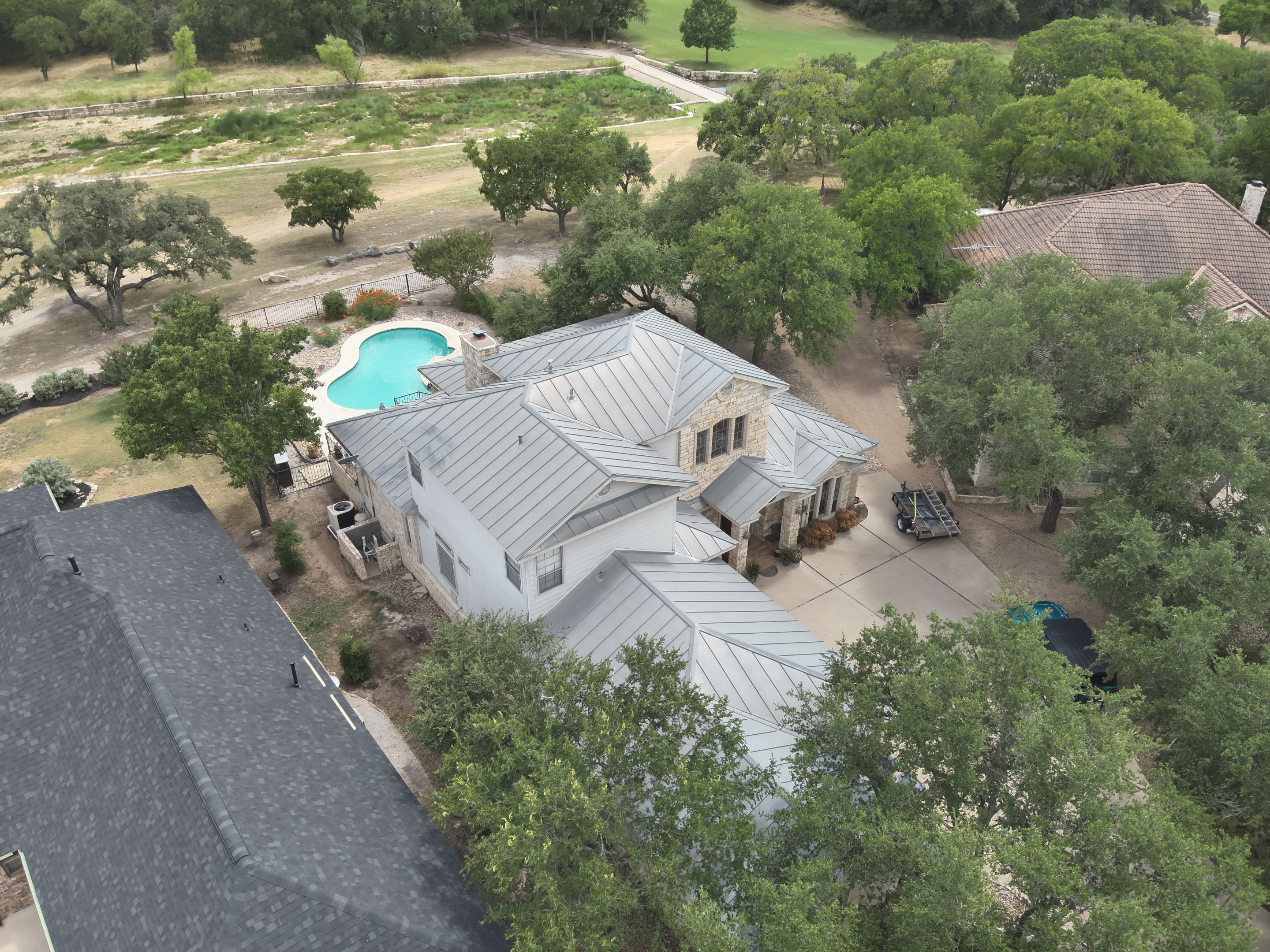 Residential Roof Replacement using 24 GA Double-Lock - Surrey Beige by Action Exteriors Austin