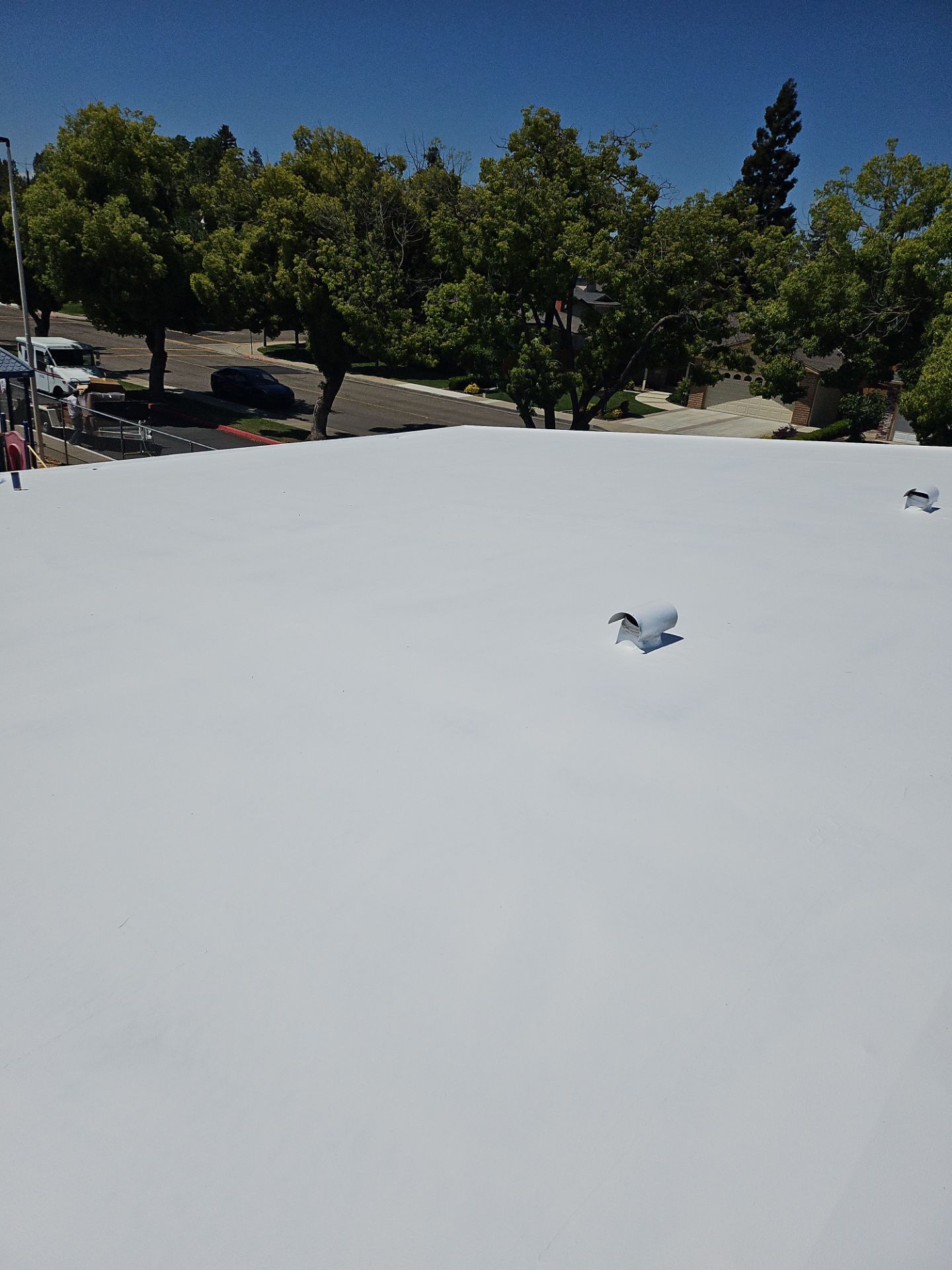 Single-ply restoration system using Benchmark/PUMA XL coatings over TPO single-ply roofing by Straight Edge Roofing Inc