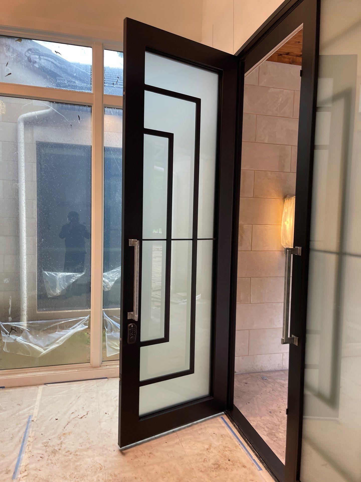 Modern Metal and Glass Entryway Installation with Custom Hardware Finishing in Dallas by Solara Custom Living
