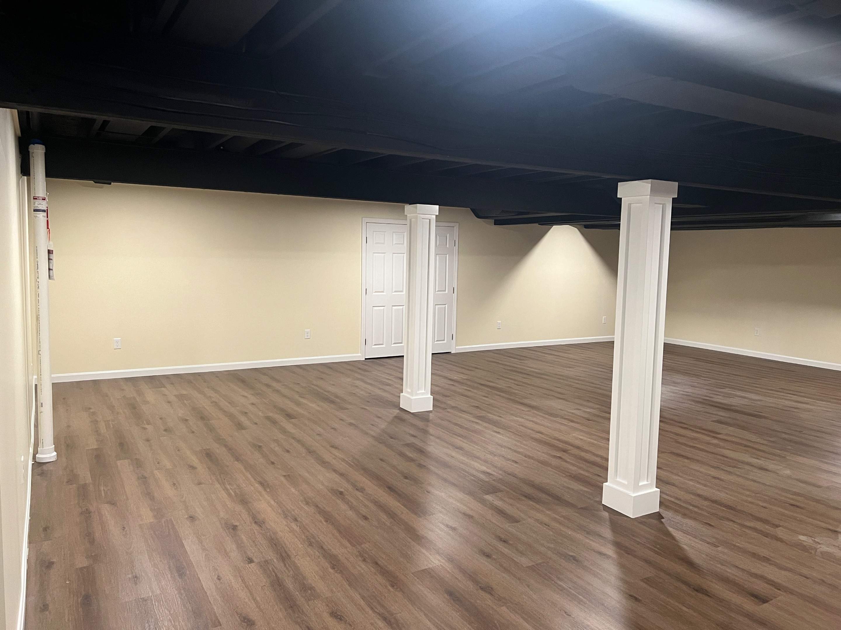Basement Remodel w/ LVP Flooring & Exposed Ceiling by Chagnon Building & Remodeling LLC